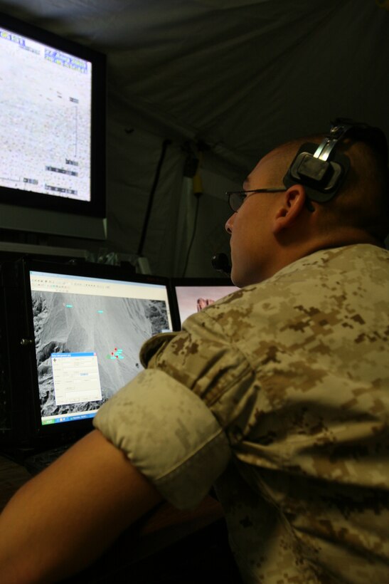 Lance Cpl. Robert Landreth, an intelligence specialist with Marine Unmanned Aerial Vehicle Squadron 1, observes the flight path of the RQ-7 Shadow UAV Aug. 27 at the Expeditionary Airfield during the squadron’s last training exercise before deploying to Iraq .