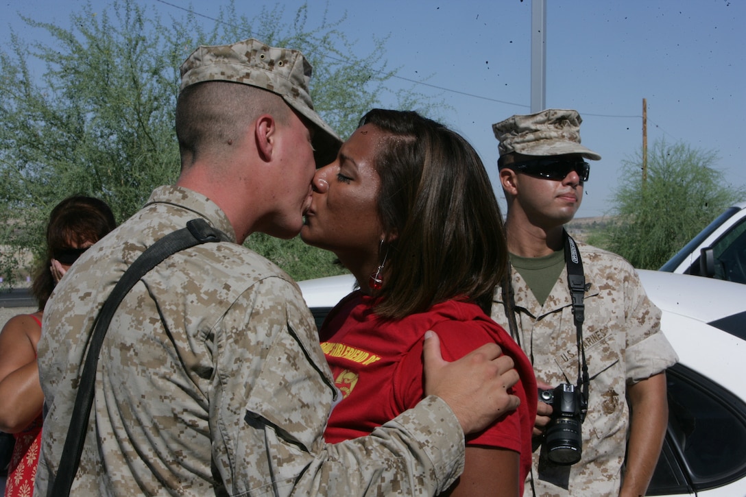 Lance Cpl. Joseph Michael Peregrina, rifleman with Kilo Company, 3rd Battalion, 7th Marine Regiment, kisses his girlfriend Brianna Santiago goodbye before leaving the Combat Center’s Unit Marshalling Area for deployment to Iraq Aug. 27.  Marines and sailors from 3/7 departed the Combat Center Aug. 26 and 27 on a seven-month deployment to Iraq in support of Operation Iraqi Freedom.  More than 1,000 Marines and sailors left the Unit Marshalling Area in the early and mid-morning hours of both days to the waves and tears of their families and loved ones.::r::::n::