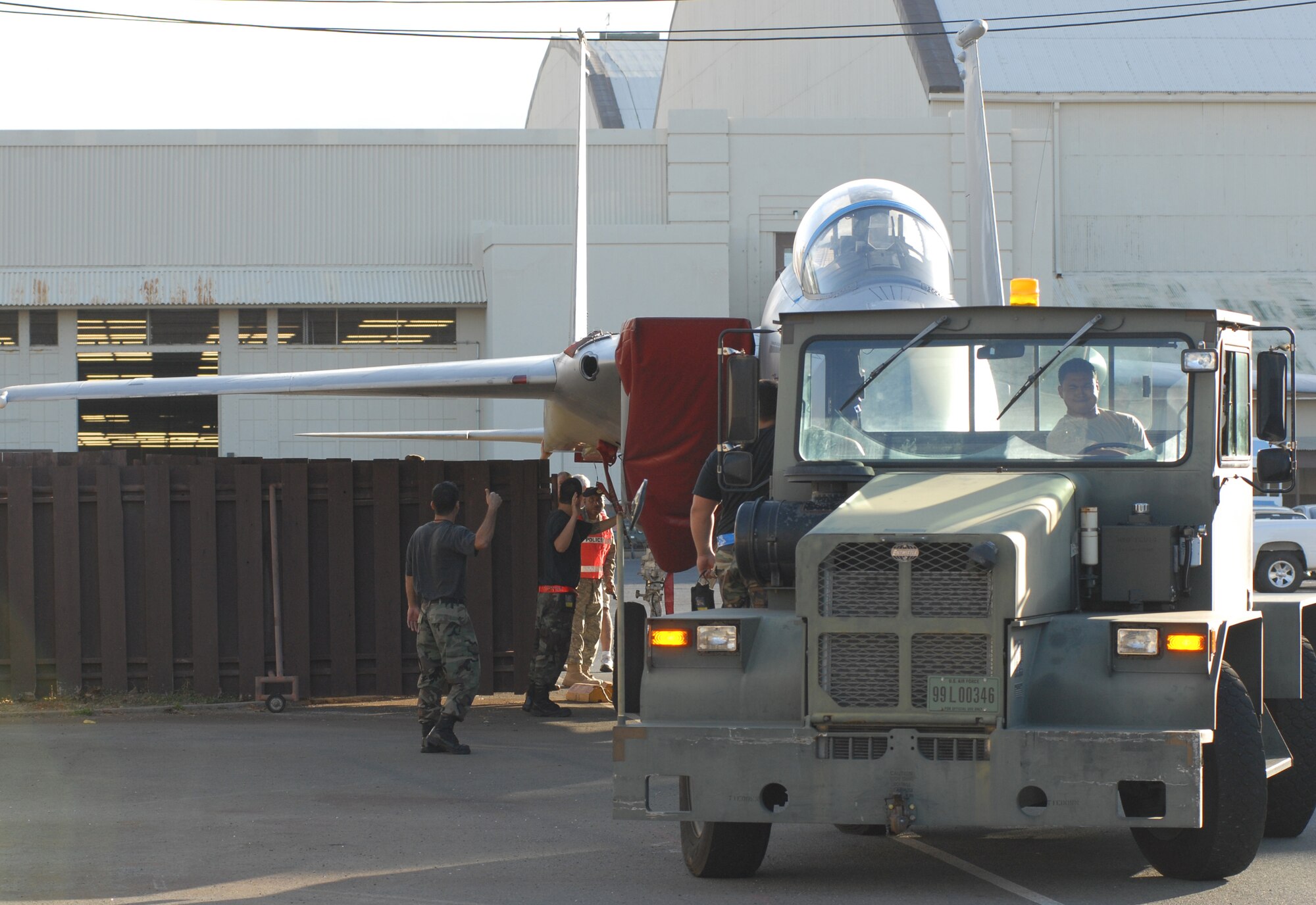 With a few inches to spare, tug driver Staff Sgt. Robert Rabacal, 154th Maintenance Squadron, Hawaii Air National Guard receives directions from tow supervisor, Staff Sgt. Jacob Correa an F-15 crew chief with the 154th MXS, on which way to turn. Sergeant Jacob is pictured on the side step of the tug. The F-15 Eagle became a part of the pacific Aviation Museum Pearl Harbor, Ford Island Hawaii static aircraft displays, Aug. 26, 2008. (U.S. Air Force Photo/ Master Sgt. Robert Burgess)