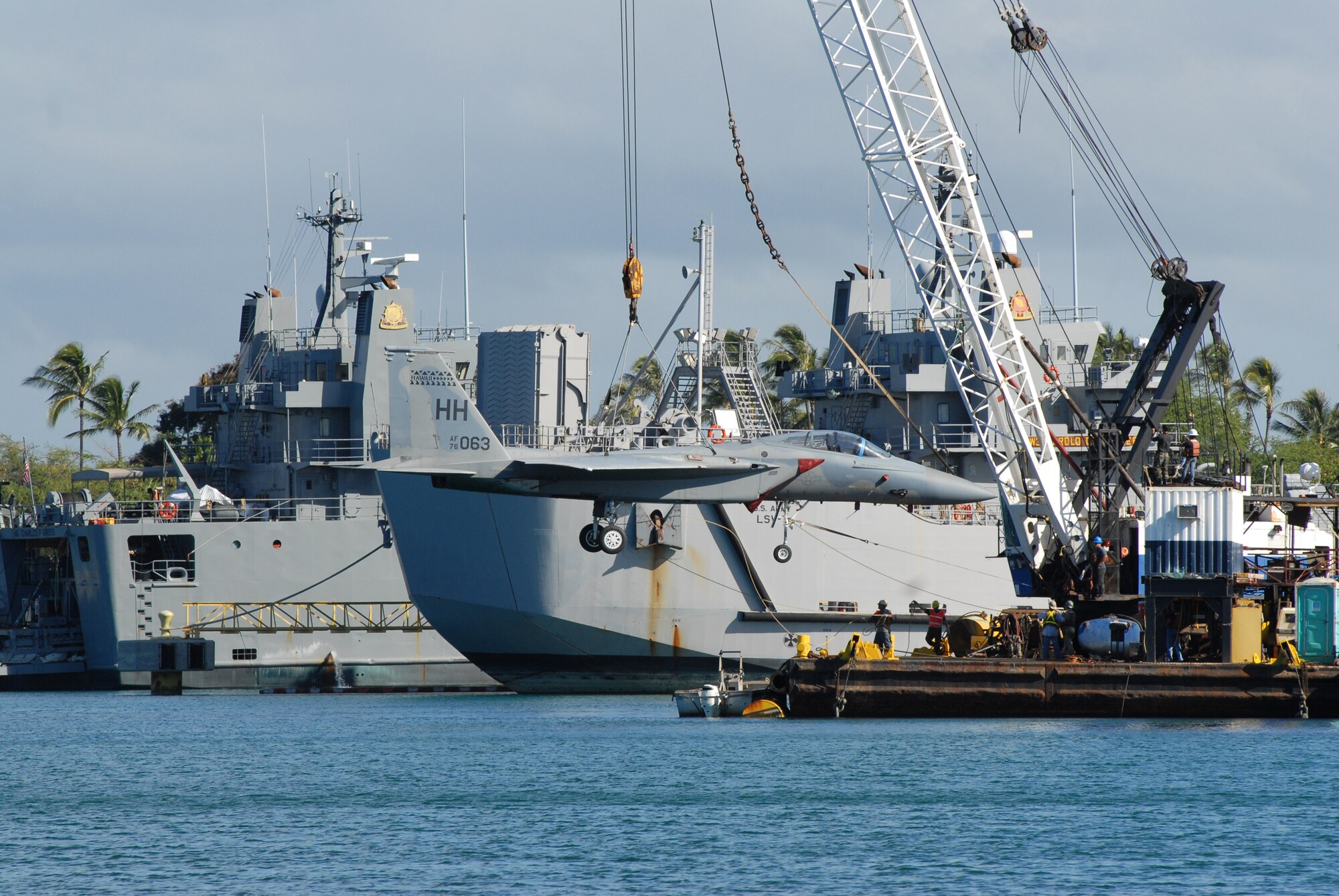 An F-15A from the 199th Fighter Squadron, Hawaii Air National Guard gets a lift from a barge crane on the morning of Aug. 26, 2008 at Hickam’s Cargo Pier for its maiden vogue to the Pacific Aviation Museum Pearl Harbor, Ford Island Hawaii. A team of maintainers from the 154th Maintenance Squadron, HIANG managed towed the aircraft through a narrow corridor to meet the loading time of the F-15 Eagle.  (U.S. Air Force Photo/Master Sgt. Robert Burgess)