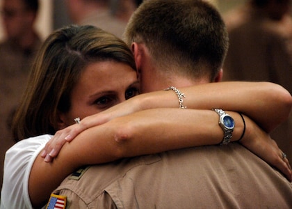 Fiancé Jessica McDonnell embraces Capt. Alexander Lammi, prior to the 15th Airlift Squadron departure at the base terminal here Aug. 27. Members from the 15 AS are deploying to Southwest Asia as part of Operations Enduring and Iraqi Freedom. Captain Lammi is a pilot with the 15 AS. (U.S. Air Force photo/Airman 1st Class Timothy Taylor)