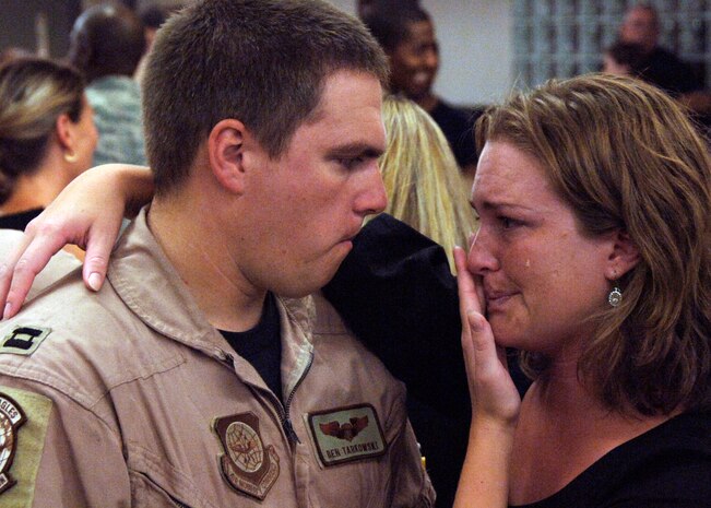 Capt. Ben Tarkowski and wife Ericka, say their goodbyes before leaving each other’s side at the base terminal here Aug. 27. The 15th Airlift Squadron is deploying to Southwest Asia and will replace the 14th Airlift Squadron from Charleston AFB, who will be returning home in about a week. Captain Tarkowski is with the 15th AS. (U.S. Air Force photo/Airman 1st Class Timothy Taylor)