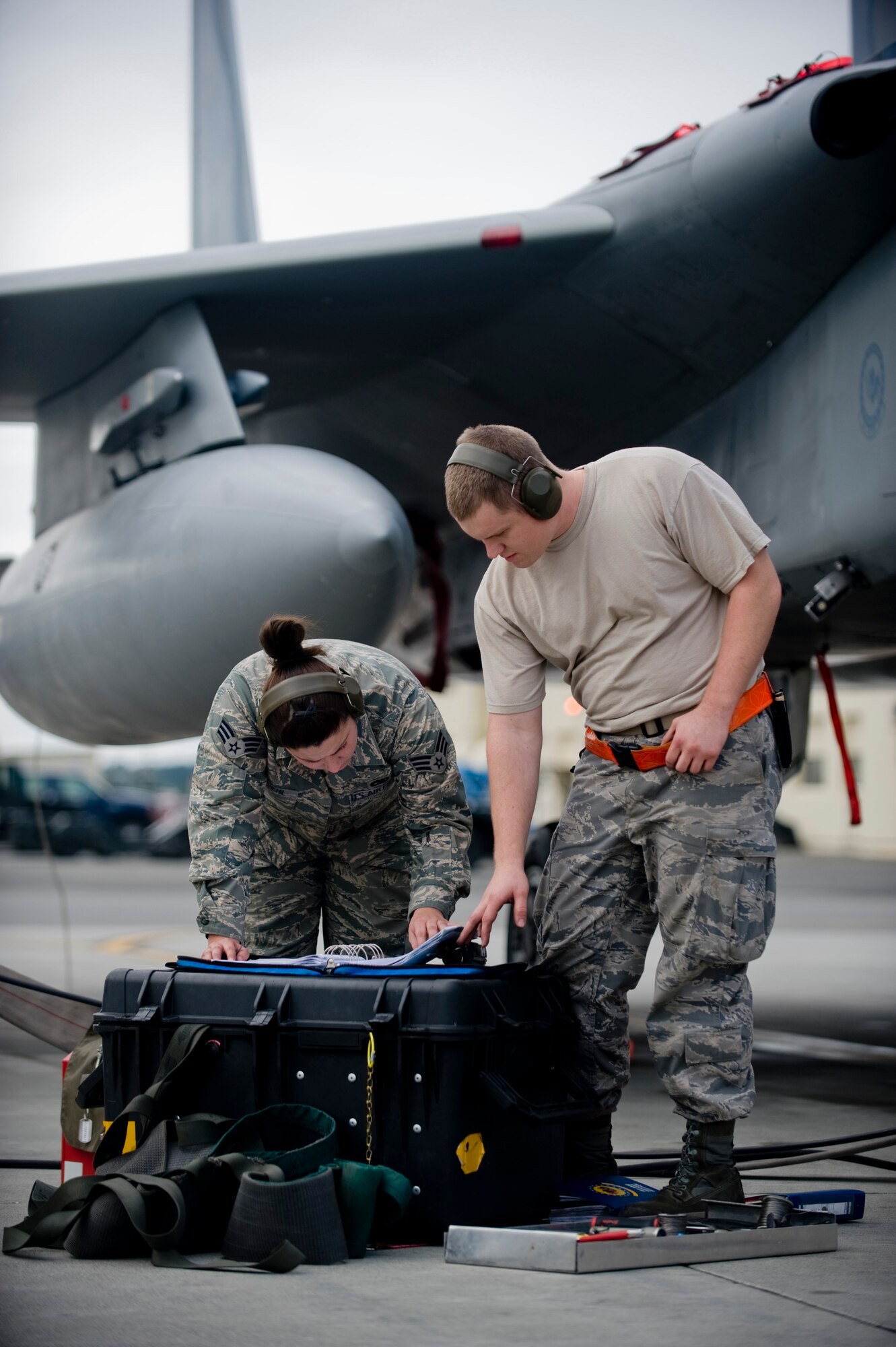 ELMENDORF AIR FORCE BASE, Alaska -- Senior Airman Shawna Reinoehl and Airman 1st Class Kaleb Gentrup, 3rd Component Maintenance Squadron, look over forms after performing maintenance on a 19th Fighter Squadron F-15C Aug. 27. The 19th FS is the only F-15 squadron in Alaska. (U.S. Air Force photo/Senior Airman Jonathan Steffen)