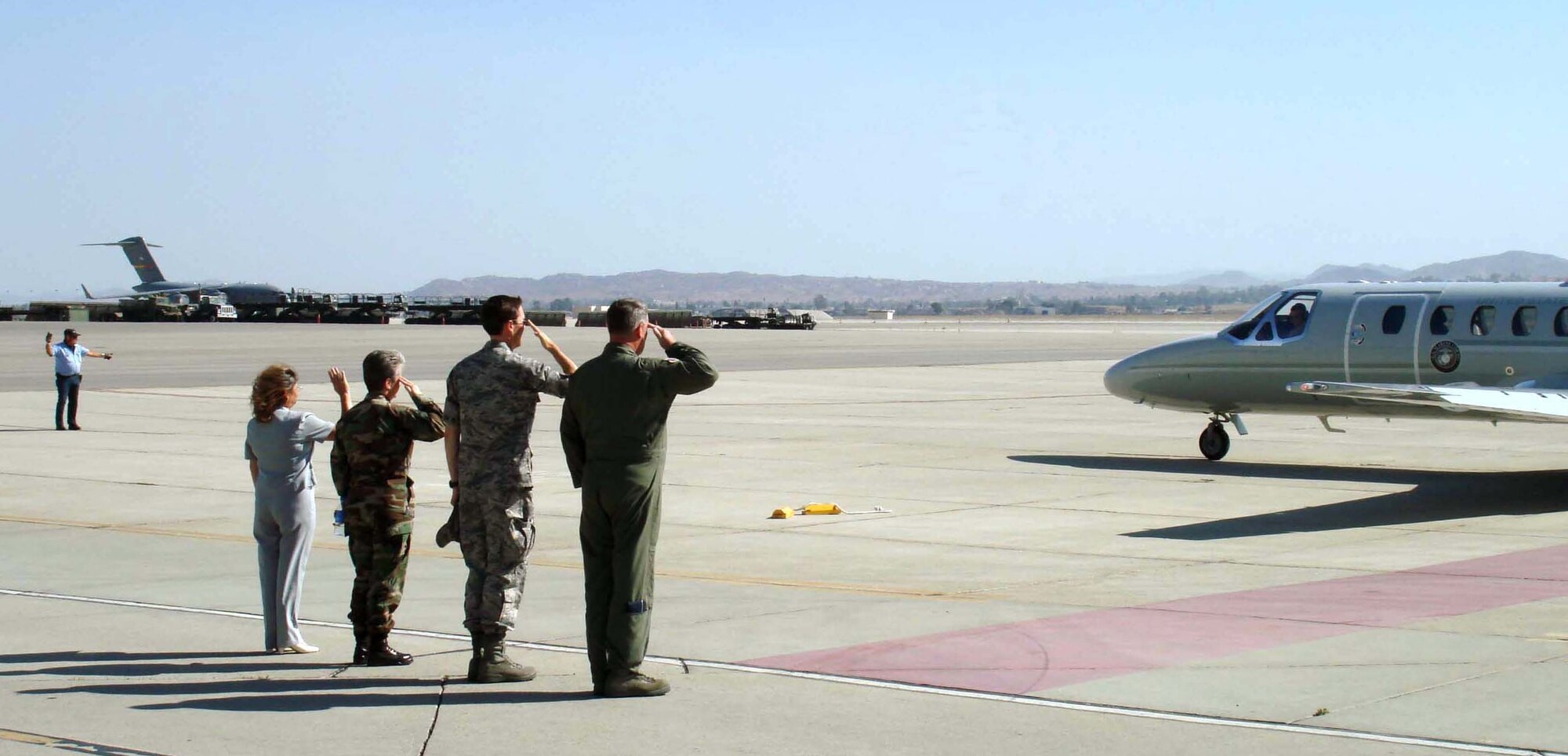 Representatives from March ARB await the departure of Lt. Gen. Stenner after his visit here. From left are: Elaine Plein, 452 Air Mobility Wing protocol officer, Maj. Maureen H. McAllen, Fourth Air Force executive officer, Col. Jeffrey K. Barnson, 452 AMW vice commander, and Maj. Gen. Robert E. Duignan, 4 AF commander. (U.S. Air Force photo by Maj. Andra P. Higgs, 4th AF/PA)