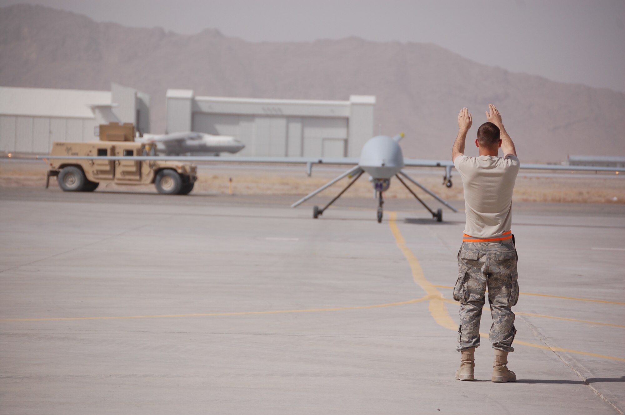 Staff Sgt. Skyler Swinhart, 163d Aircraft Maintenance Squadron Crew Chief, recovers
an MQ-1 Predator at Kandahar International Airport, in Afghanistan. (U.S. Air Force photo)