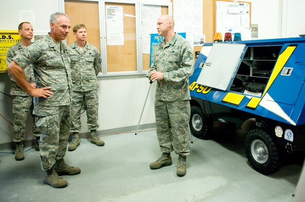 Tech. Sgt. Jason Rickman, 62nd Aircraft Maintenance Squadron, briefs Maj. Gen. Winfield "Skip" Scott, III, 18th Air Force commander on Air Force Smart Operations for the 21st Century trailer initiatives in the consolodated tool kit shop here Aug. 27. (U.S. Air Force photo/Abner Guzman) 