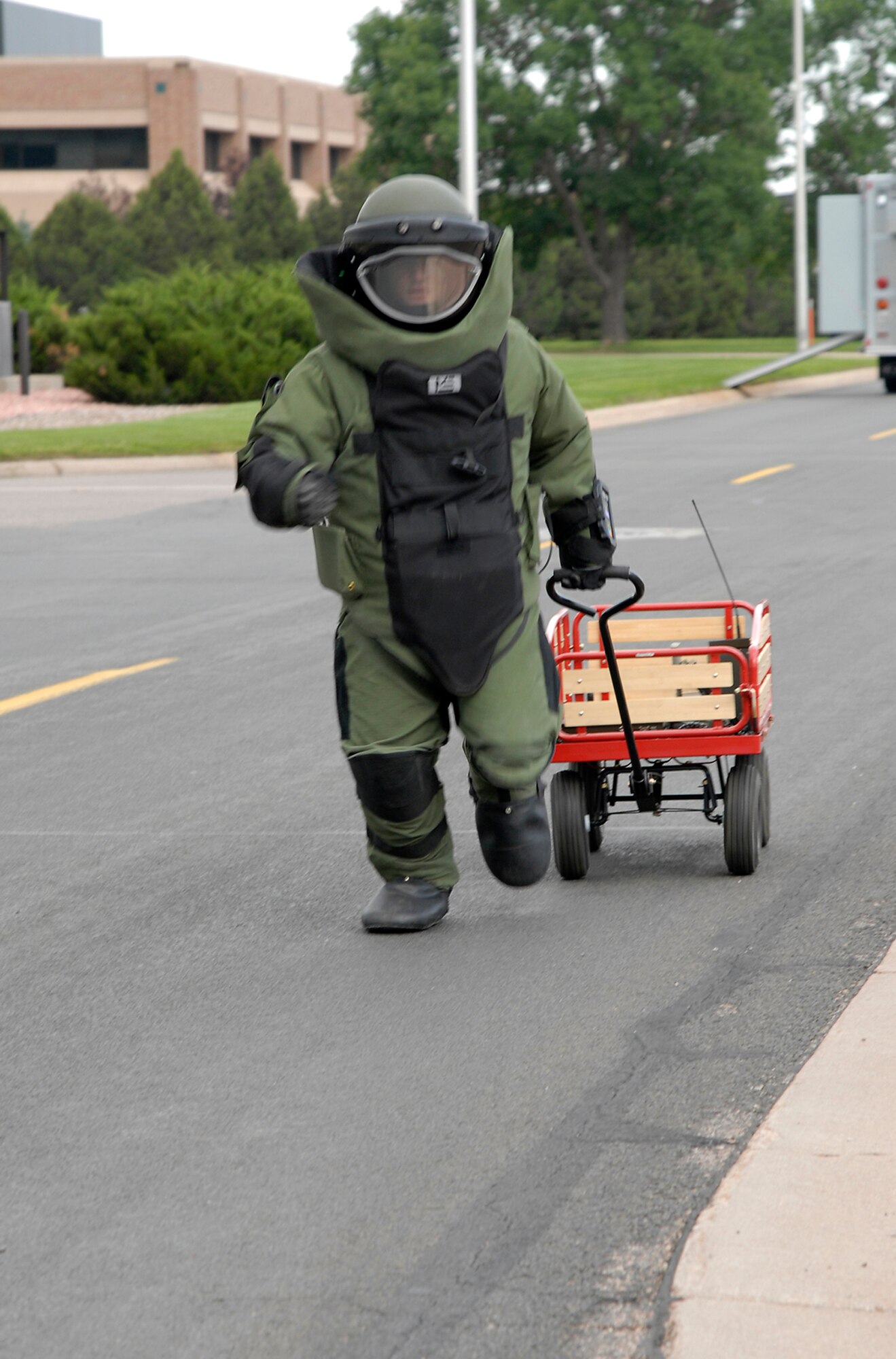 An explosives ordnance disposal member moves toward a simulated suspicious package to remove it from a scene Aug. 20 during Condor Crest 08-05 events at Peterson Air Force Base, Colo. The week-long exercise encompassed several scenarios that challenged Airmen. The scenarios included an intruder on base, severe weather inflicted damage on the base and simulated aircraft accidents. (U.S. Air Force photo/Roberta McDonald)