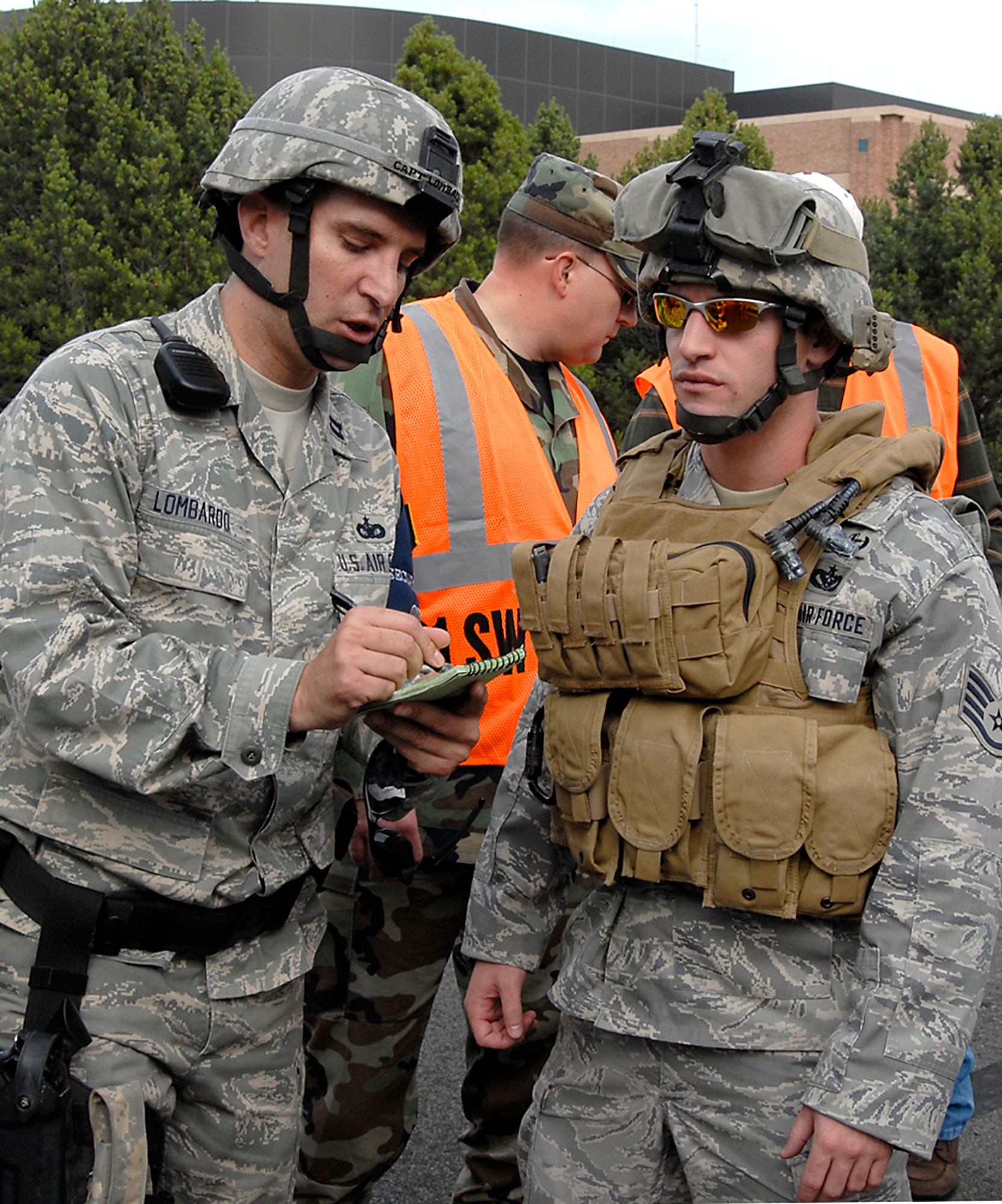 Capt. Lombardo advises a security forces Airmen as they search for a simulated suspect Aug. 20 during Condor Crest 08-05 events at Peterson Air Force Base, Colo. The week-long exercise encompassed several scenarios that challenged Airmen. The scenarios included an intruder on base, severe weather inflicted damage on the base and simulated aircraft accidents. Captain Lombardo and the Airman are assigned to the 21st Security Forces Squadron. (U.S. Air Force photo/Roberta McDonald)