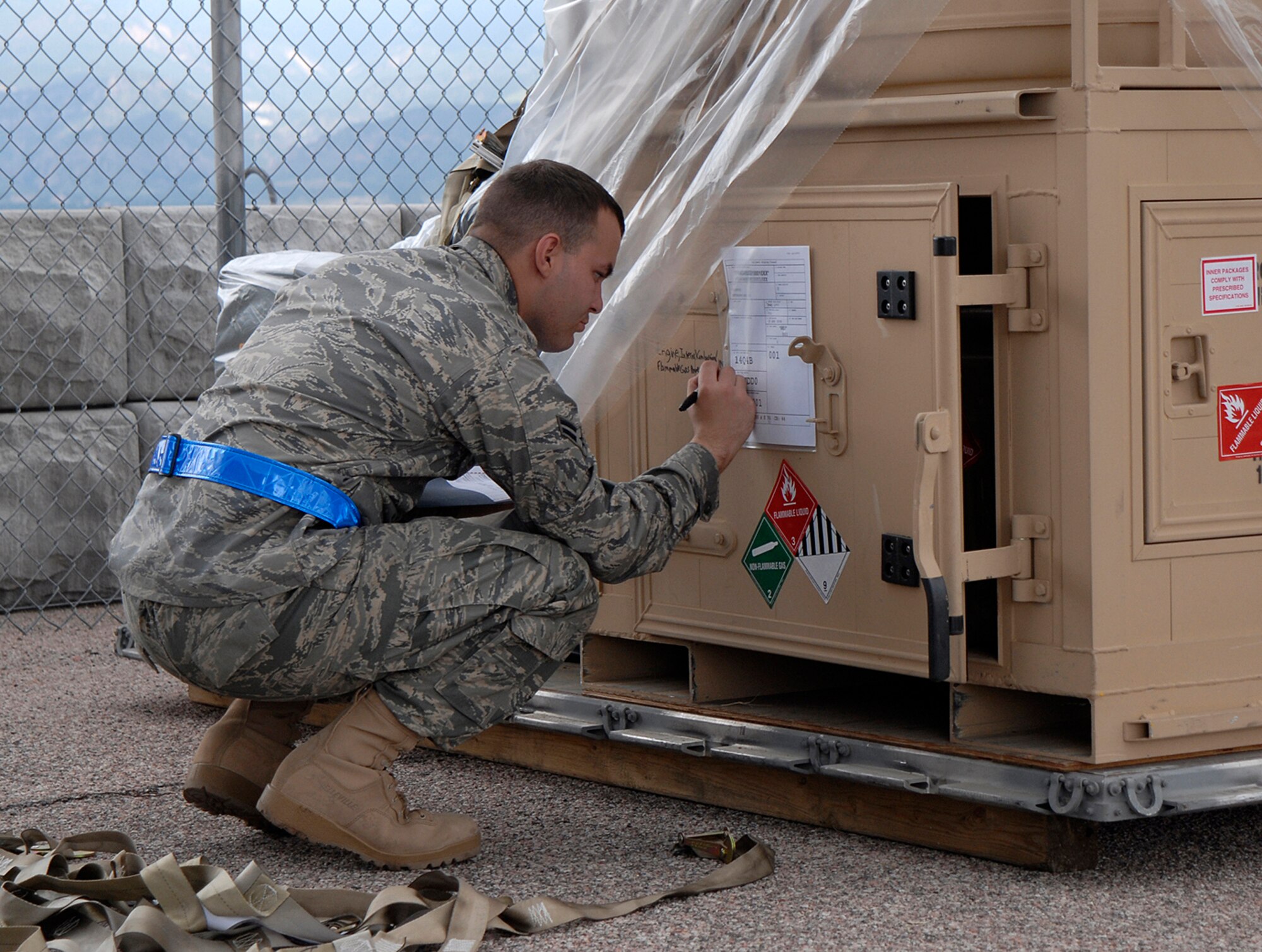 An Airman ensures proper compliance of cargo shipments Aug. 18 during Condor Crest 08-05 events at Peterson Air Force Base, Colo. The week-long exercise encompassed several scenarios that challenged Airmen. The scenarios included an intruder on base, severe weather inflicted damage on the base and simulated aircraft accidents. (U.S. Air Force photo/Craig Denton)