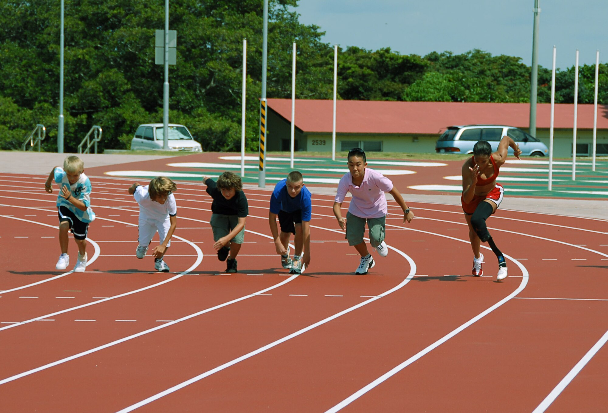 Paralympian April Holmes of Chula Vista, Calif., races students Aug. 26 at Ryukyu Middle School on Kadena Air Base, Japan.  Holmes is the world record holder in the 100-, 200- and 400-meter dashes.  More than 100 athletes and support staff from the U.S. Paralympics track and field and swim teams arrived on Kadena AB Aug. 24 to live and train for the next ten days in preparation for the 2008 Paralympic Games being held in Beijing, China, Sept. 6. (U.S. Air Force photo/Airman First Class Aaron Johnson)