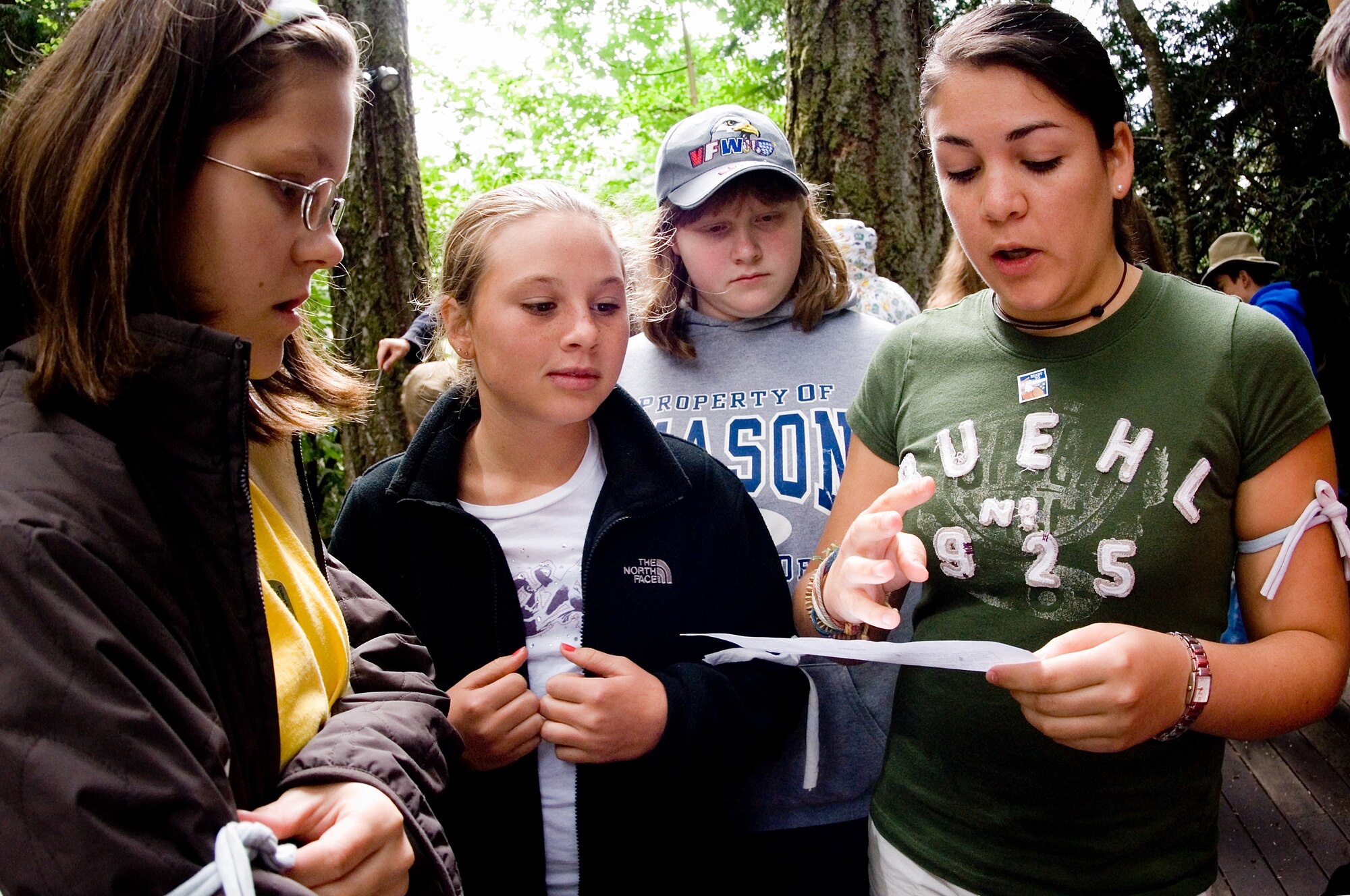 Airman 1st Class Ana Leal-Morales, a camp counselor and 62nd FSS member, instructs campers on the rules of an outdoor game.