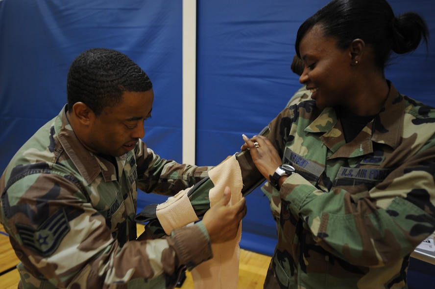 MOODY AIR FORCE BASE, Ga. – Staff Sgt. Lawrence Eakins, 23rd Mission Support Group client support administrator, left, puts a splint on Airman 1st Class Shamekia Starling, 23rd MSG CSA, during self-aid buddy care training here Aug. 26. Airmen must complete the course every two years and within 90 days of a deployment. (U.S. Air Force photo by Senior Airman Gina Chiaverotti)