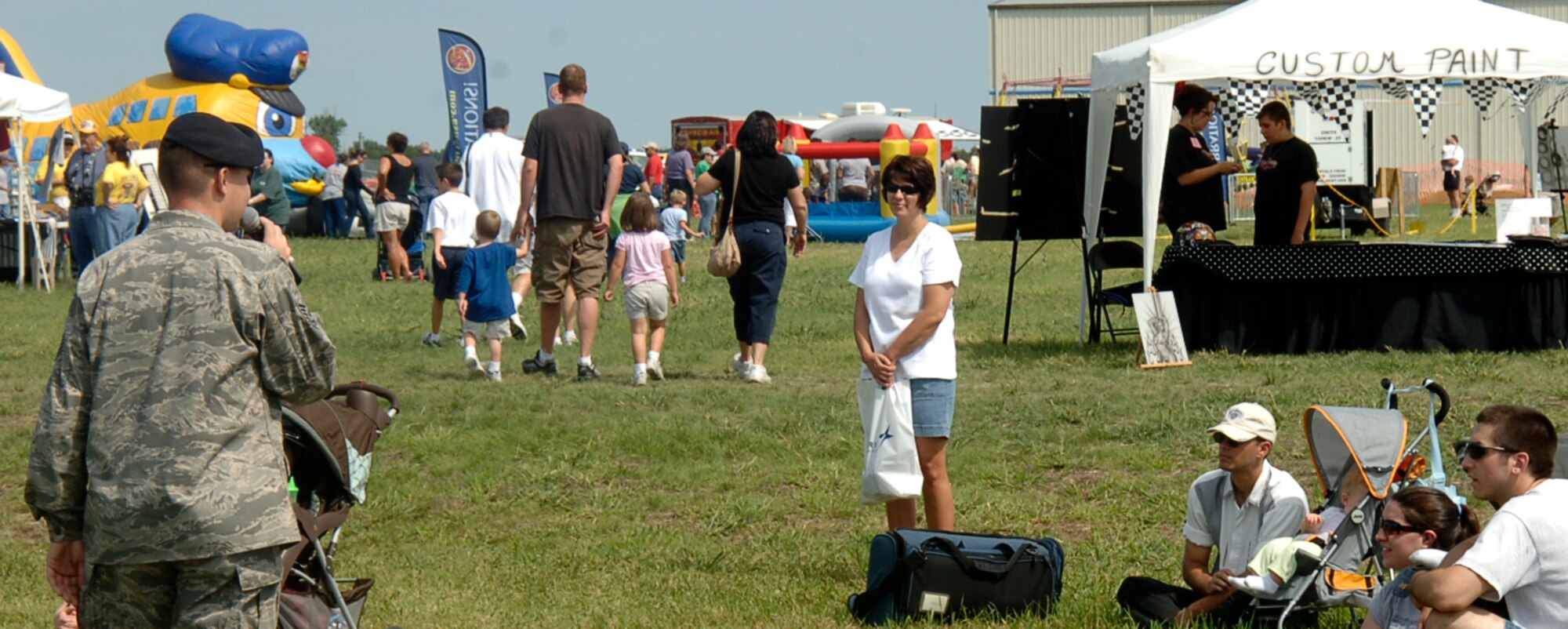 MCCONNELL AIR FORCE BASE, Kan. --Tech. Sgt. Andrew Bedell, 22nd Security Forces Squadron, explains what is happening during a military working dog demonstration to a crowd at the Colonel James Jabara Airport during the Wichita flight Festival, Aug. 23. Along with the military working dog demonstration, McConnell also provided a historical display, various booths, and a KC-135 Stratotanker for the air show. (Photo by Senior Airman Laura Suttles)