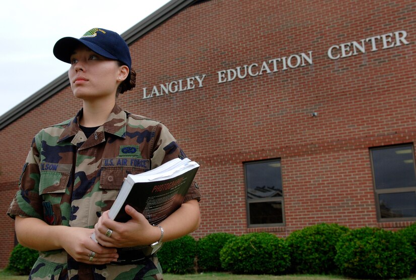 Airman 1st Class Sylvia Olson, 1st Fighter Wing Public Affairs journalist, exits the Langley Education Center here after receiving information pertaining to the Air Force's financial and education benefits on Aug. 27. (U.S. Air Force photo/Tech. Sgt. Levi Collins) 