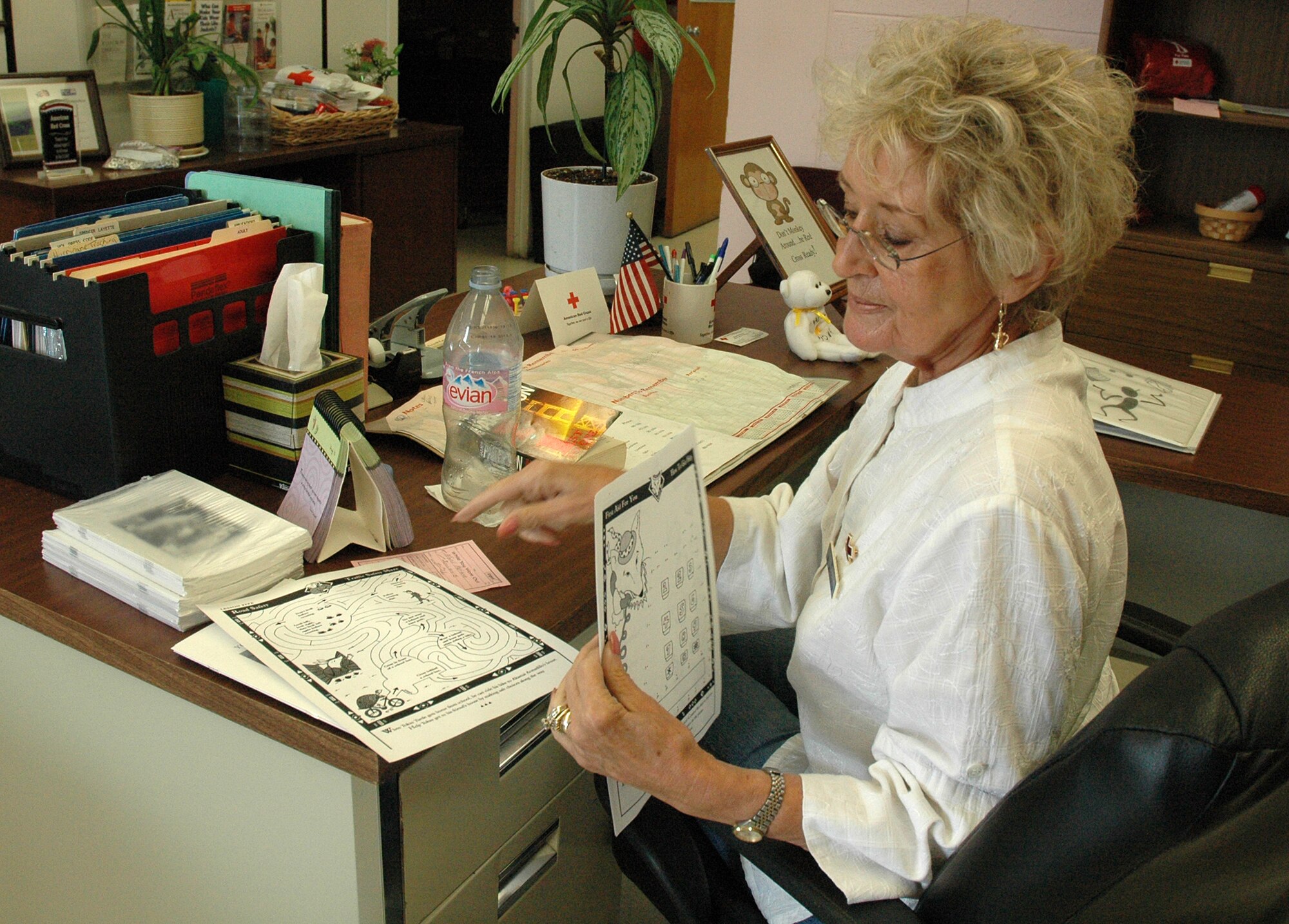EGLIN AIR FORCE BASE, Fla. -- Jan Stratton, American Red Cross volunteer, stuffs folders with children's activity papers for an upcoming ARC event. The ARC provides services to Eglin and Hurlburt personnel in a variety of ways, including health and safety classes, disaster awareness briefings and emergency communications. (U.S. Air Force photo by Staff Sgt. LuCelia Ball) 