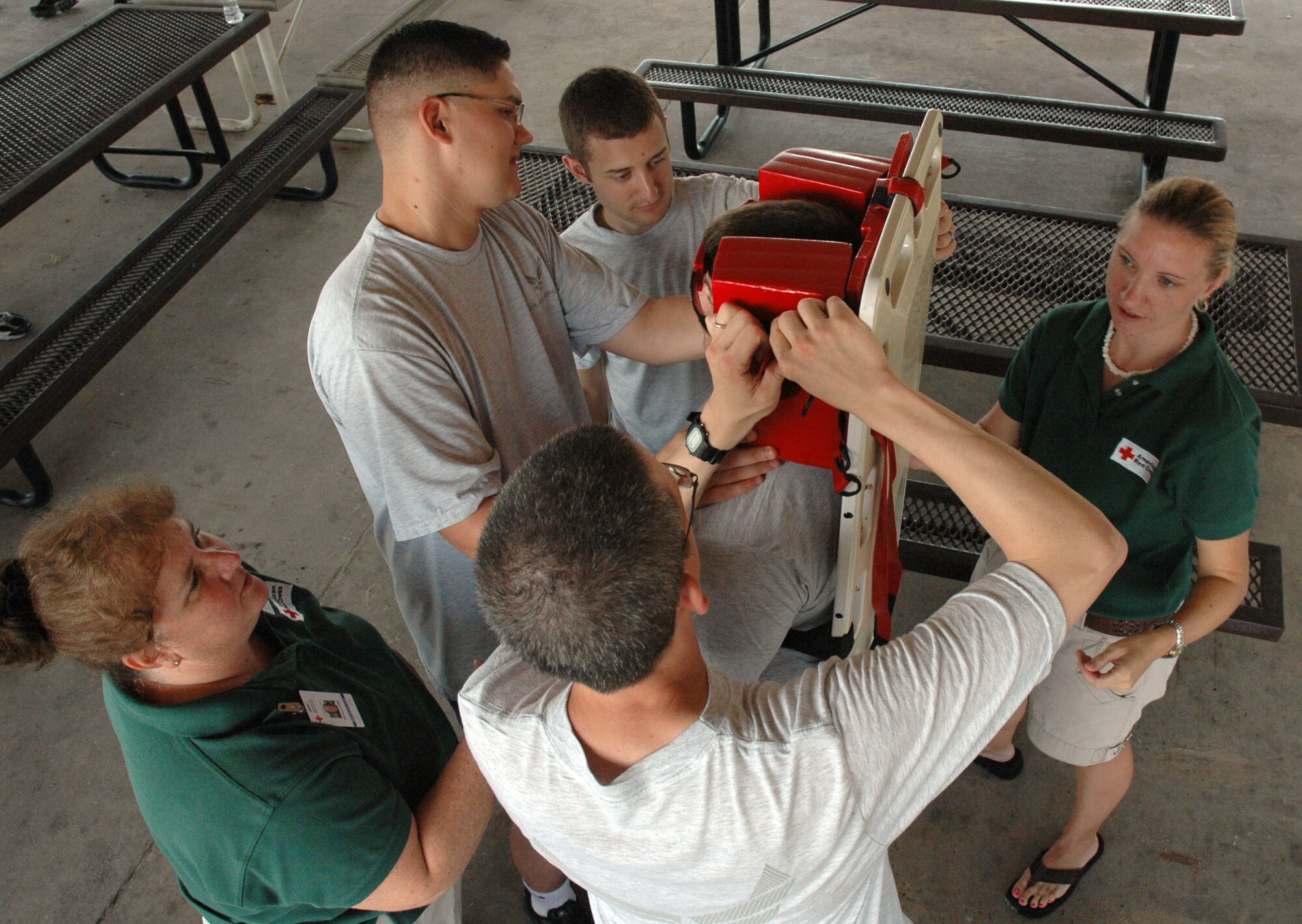 EGLIN AIR FORCE BASE, Fla. -- Two American Red Cross volunteers demonstrate the use of a backboard during a health and safety class. The ARC provides services to Eglin and Hurlburt personnel in a variety of ways, including health and safety classes, disaster awareness briefings and emergency communications. (U.S. Air Force photo by Airman 1st Class Anthony Jennings)