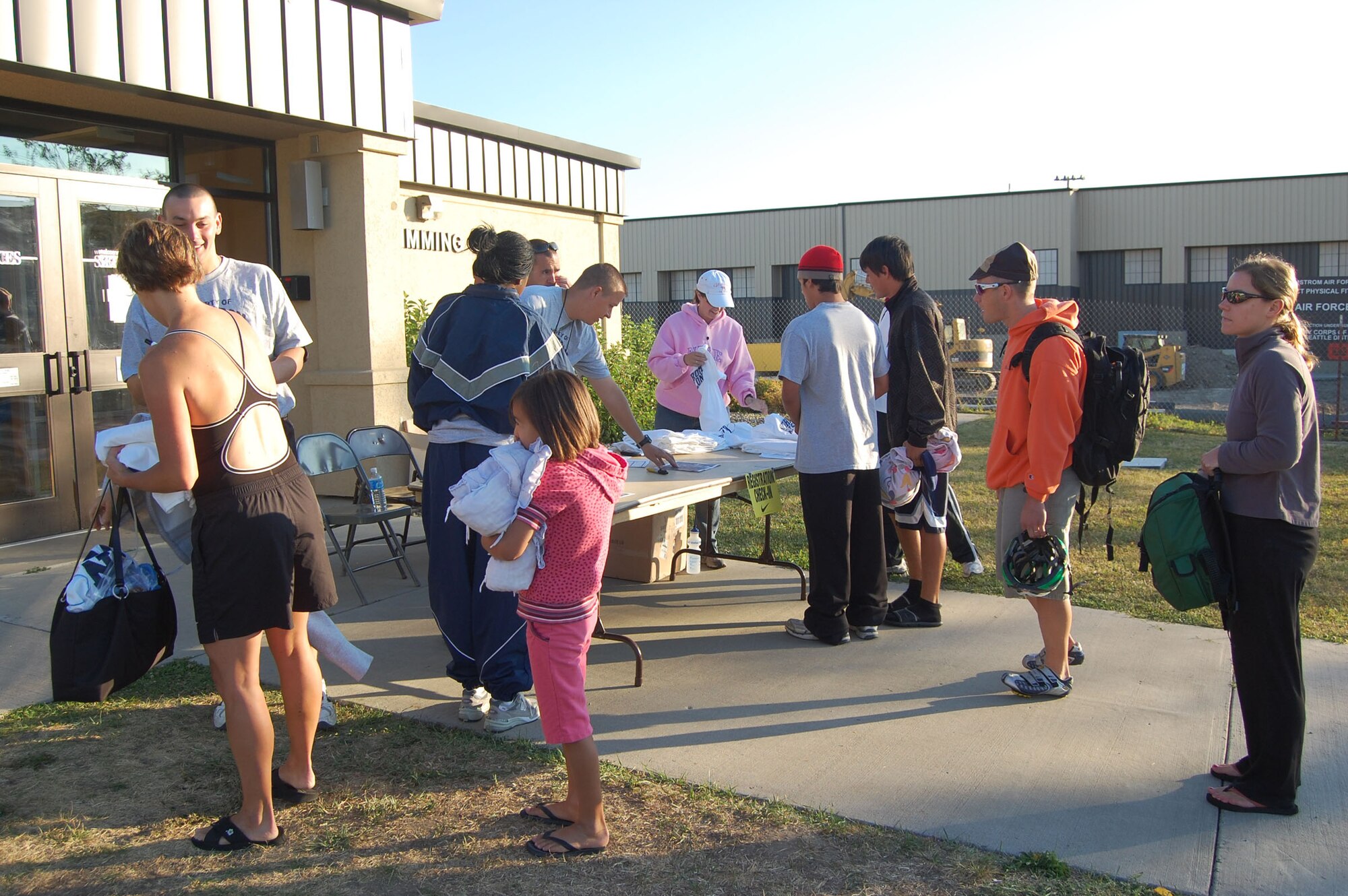 Athletes line up outside the base pool to register for a triathlon that was held on Malmstrom Aug. 23. More than 50 people participated in the event held by the Sports and Fitness Center. (U.S. Air Force photo/Senior Airman Emerald Ralston)