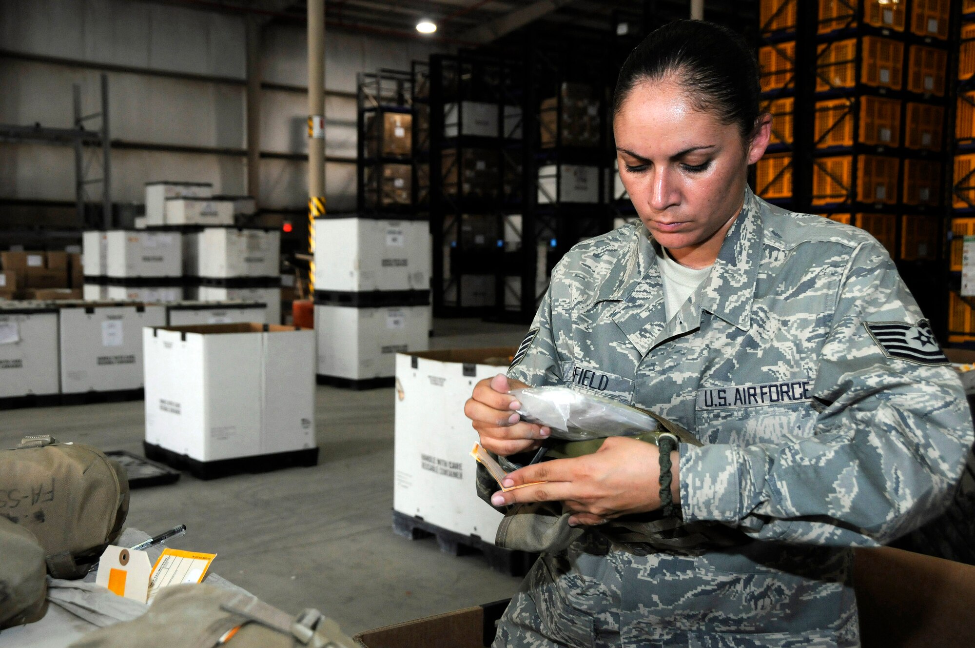 Tech. Sgt. Magdalena Winfield, verifies each separate item inside of the individual first aid kit Aug. 19. Sergeant Winfield checks the kit to make sure the lot numbers match the numbers on the DD form 1574. The first aid kits are being recertified so they may be reused and put back into use in theater. Sergeant Winfield is assigned to the 379th Expeditionary Logistic Readiness Squadron and is a native of San Antonio, is deployed from Lackland Air Force Base, Texas. (U.S. Air Force photo/Tech. Sgt. Michael Boquette) 