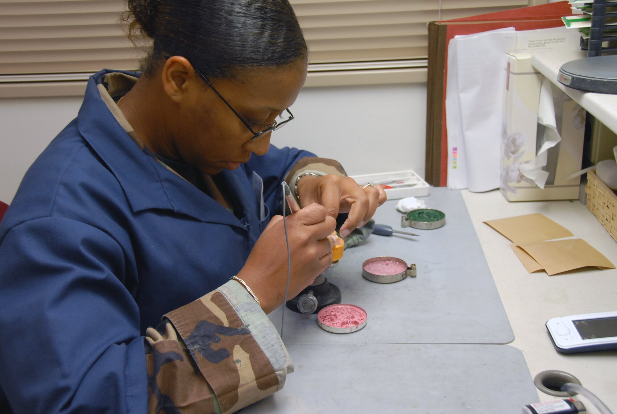 Tech. Sgt. Kesha Williams, a dental lab technician with the 18th Dental Squadron's area dental lab, prepares a wax applicator for a metal framework Aug. 19 at Kadena Air Base, Japan. (U.S. Air Force photo/Airman 1st Class Aaron Johnson) 
