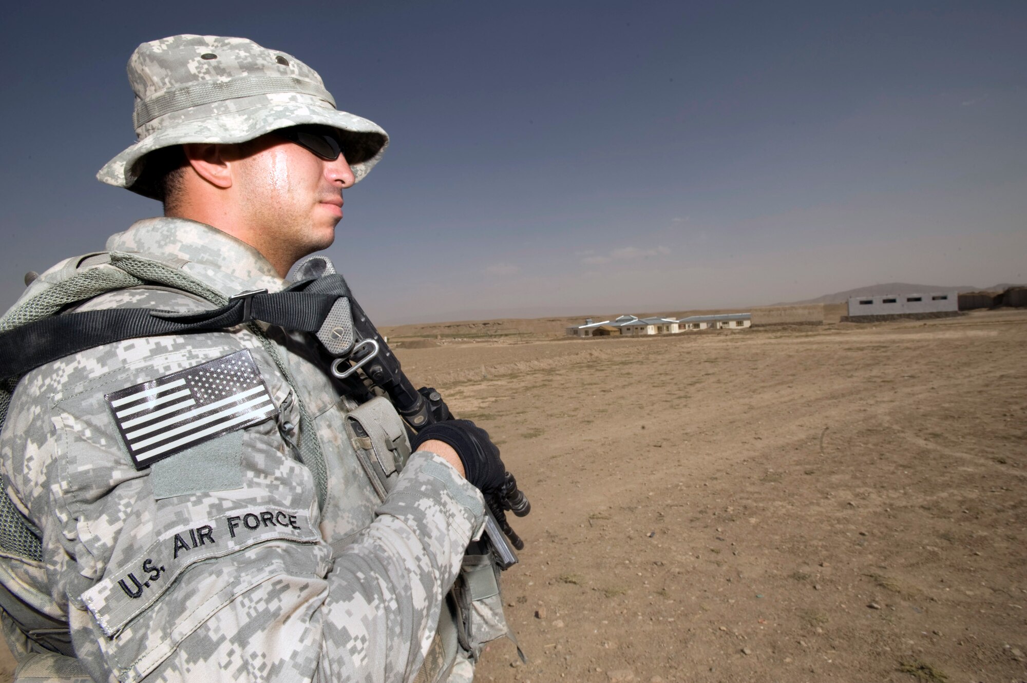Staff Sgt. Joe Montano provides security while other members of the Zabul Provincial Reconstruction Team survey construction progress made at a boys school Aug. 10 at Qalat, Afghanistan. Sergeant Montano, who is an F-15 Eagle crew chief at Nellis Air Force Base, Nev., is a mine resistant ambush protected vehicle driver and provides security for the team during his deployment here. (U.S. Air Force photo/Master Sgt. Keith Brown) 
