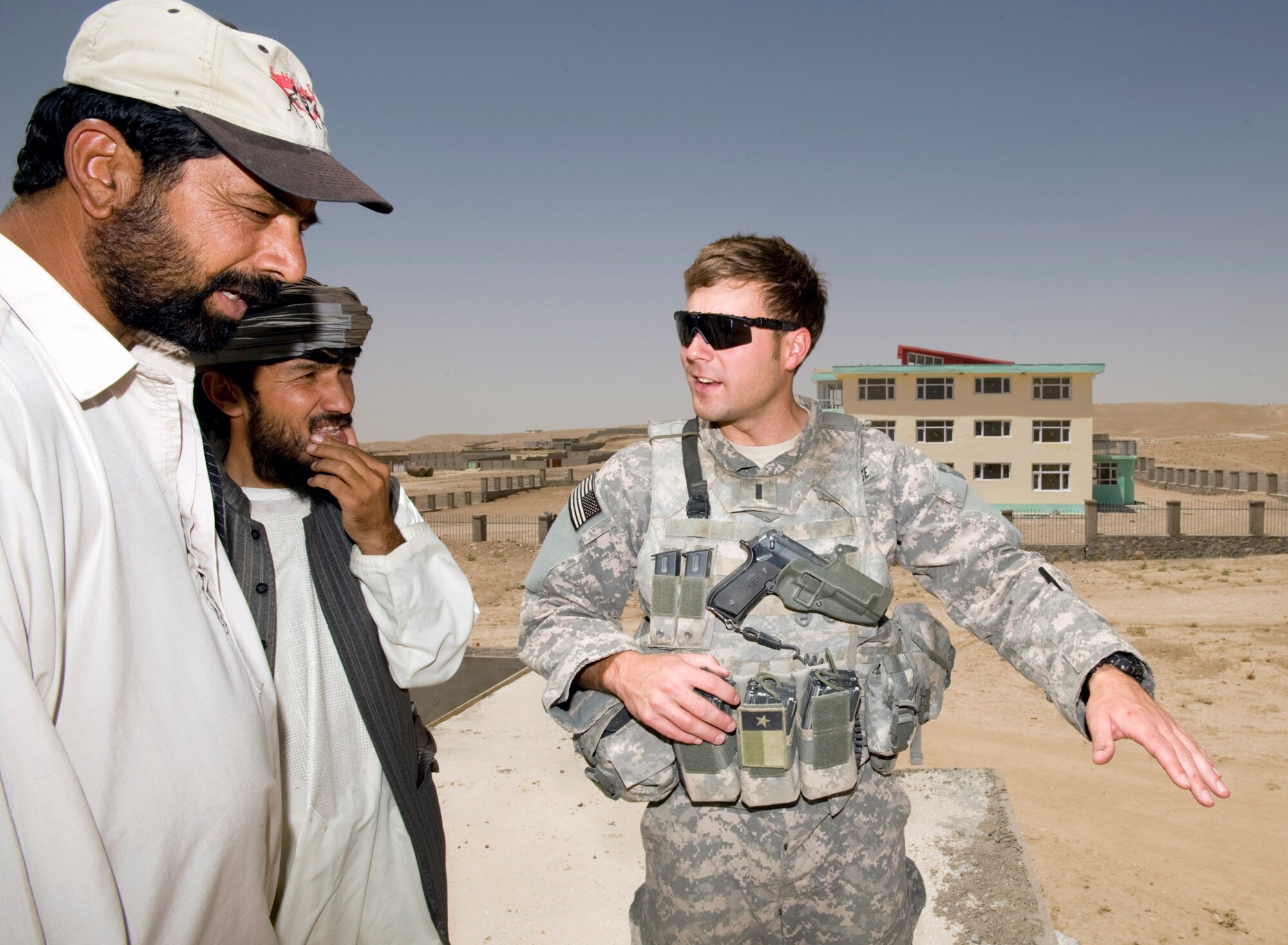 1st Lt. Adam Lazar discusses progress on the construction of a new fire station Aug. 10 at Qalat, Afghanistan. As an engineer for the Zabul Provincial Reconstruction Team, Lieutenant Lazar oversees 25 construction projects contracted out to local firms. (U.S. Air Force photo/Master Sgt. Keith Brown) 
