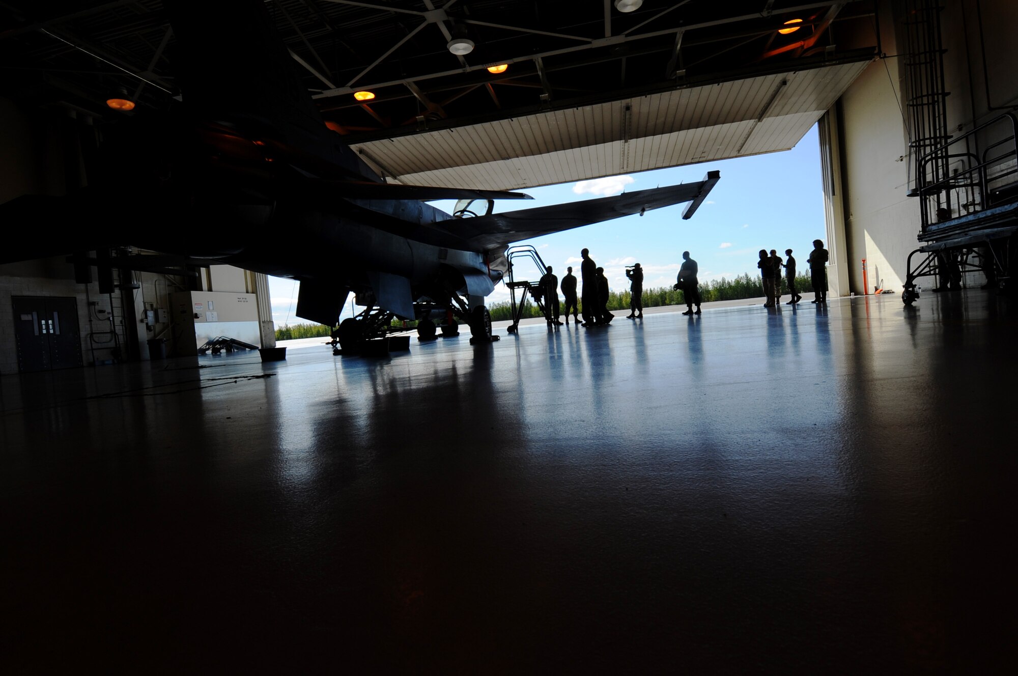 Alex Lee is greeted by 354th Aircraft Maintenance Squadron crew chiefs as he enters the hanger prior to be given a walk around tour of an F-16 Aggressor Aug. 22, 2008, at Eielson Air Force Base, Alaska. Lee was born with congenital heart defects and Down syndrome and was selected by the Make-A-Wish Foundation for the "Pilot for a Day" program hosted by the Iceman 56 organization. The purpose of this program is to ease the pain of children who lost a normal childhood due to illnesses or disabilities.  (U.S. Air Force photo by Airman 1st Class Jonathan Snyder)