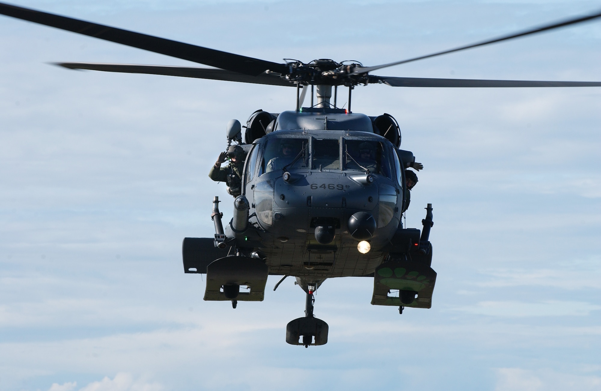 Capt. Russ Edwards, left, and Capt. Matt Calabro, right, pilot a HH-60 Pave Hawk while flight engineers Tech. Sgt. Scott Stewart, left, and Staff Sgt. Jake Seigneur, right, wave to Alex Lee Aug. 22, 2008, at Eielson Air Force Base, Alaska. Lee was born with congenital heart defects and Down syndrome and was selected by the Make-A-Wish Foundation for the "Pilot for a Day" program hosted by the Iceman 56 organization.  The purpose of this program is to ease the pain of children who lost a normal childhood due to illnesses or disabilities. The pilots and engineers are assigned to the Det. 1, 210th Rescue Squadron.  (U.S. Air Force photo by Airman 1st Class Jonathan Snyder)
