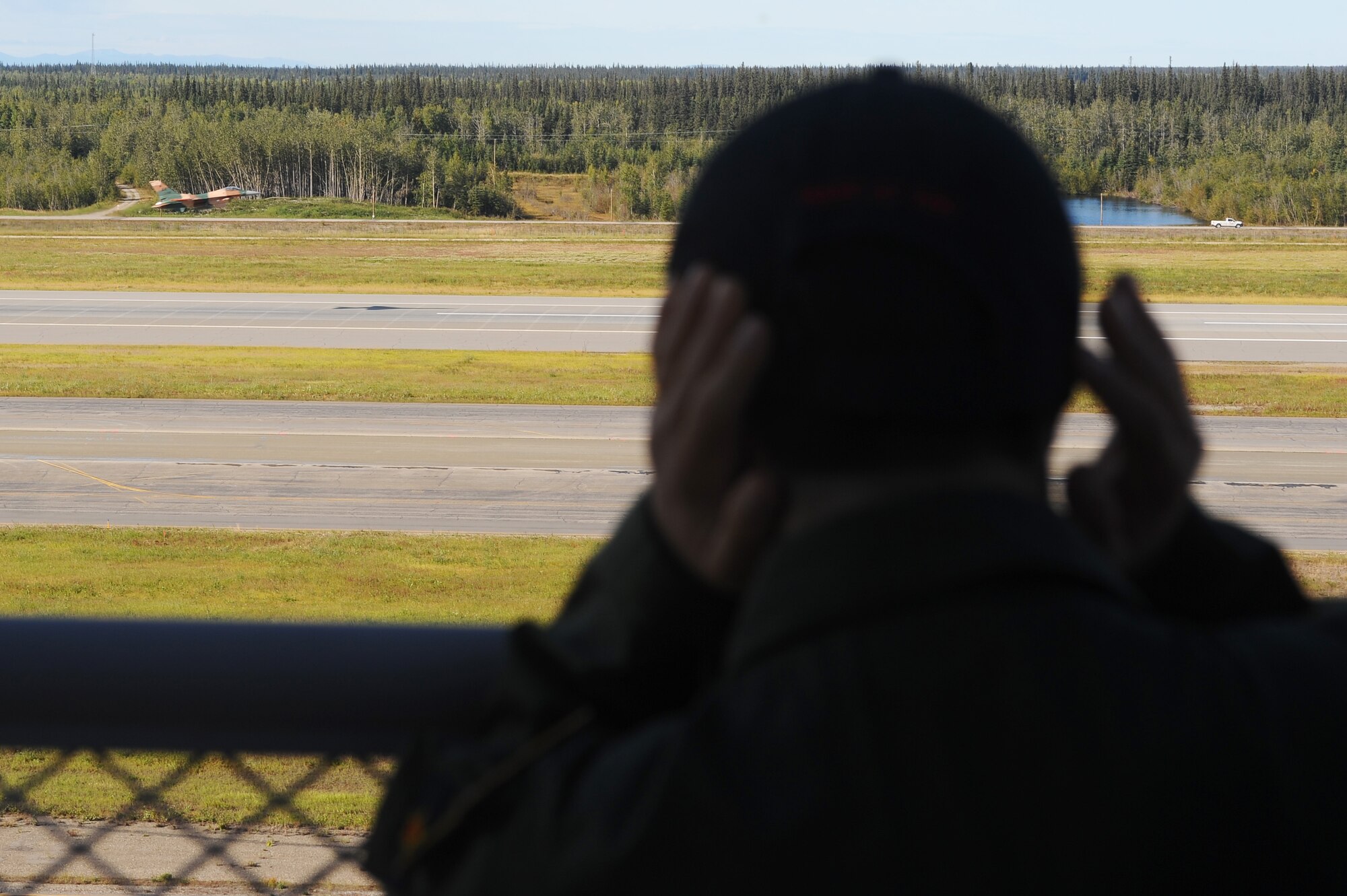 Alex Lee covers his ears as he watches a F-16 Aggressor take off from the flightline Aug. 22, 2008, at Eielson Air Force Base, Alaska. Lee was born with congenital heart defects and Down syndrome and was selected by the Make-A-Wish Foundation for the "Pilot for a Day" program hosted by the Iceman 56 organization. The purpose of this program is to ease the pain of children who lost a normal childhood due to illnesses or disabilities.  (U.S. Air Force photo by Airman 1st Class Jonathan Snyder)