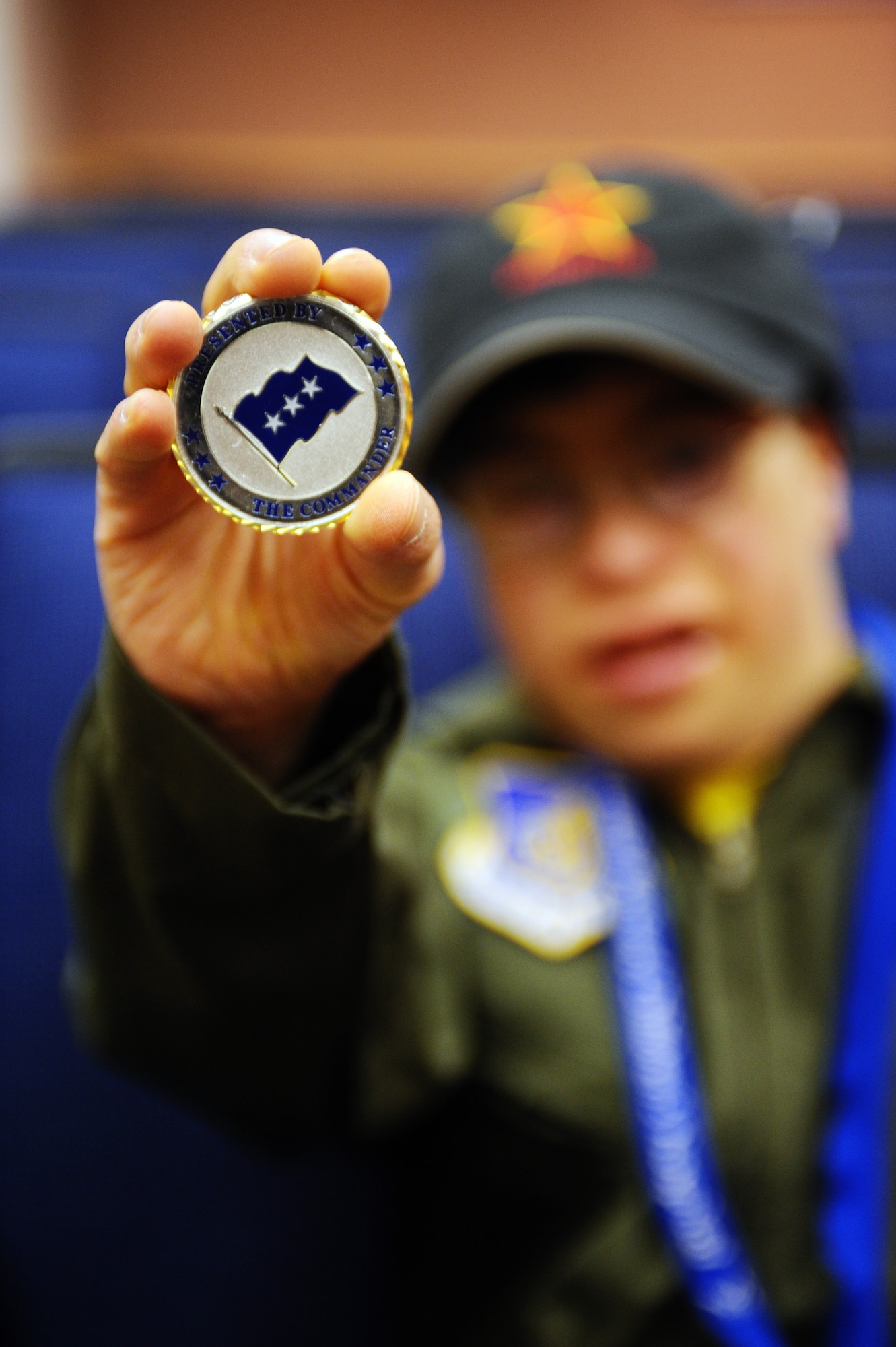Alex Lee holds up a challenge coin he received today from Lt. Gen. Dana Atkins, 11th Air Force commander, during his tour of the 18th Aggressor Squadron building Aug. 22, 2008, at Eielson Air Force Base, Alaska. Lee was born with congenital heart defects and Down syndrome and was selected by the Make-A-Wish Foundation for the "Pilot for a Day" program hosted by the Iceman 56 organization. The purpose of this program is to ease the pain of children who lost a normal childhood due to illnesses or disabilities.  (U.S. Air Force photo by Airman 1st Class Jonathan Snyder)