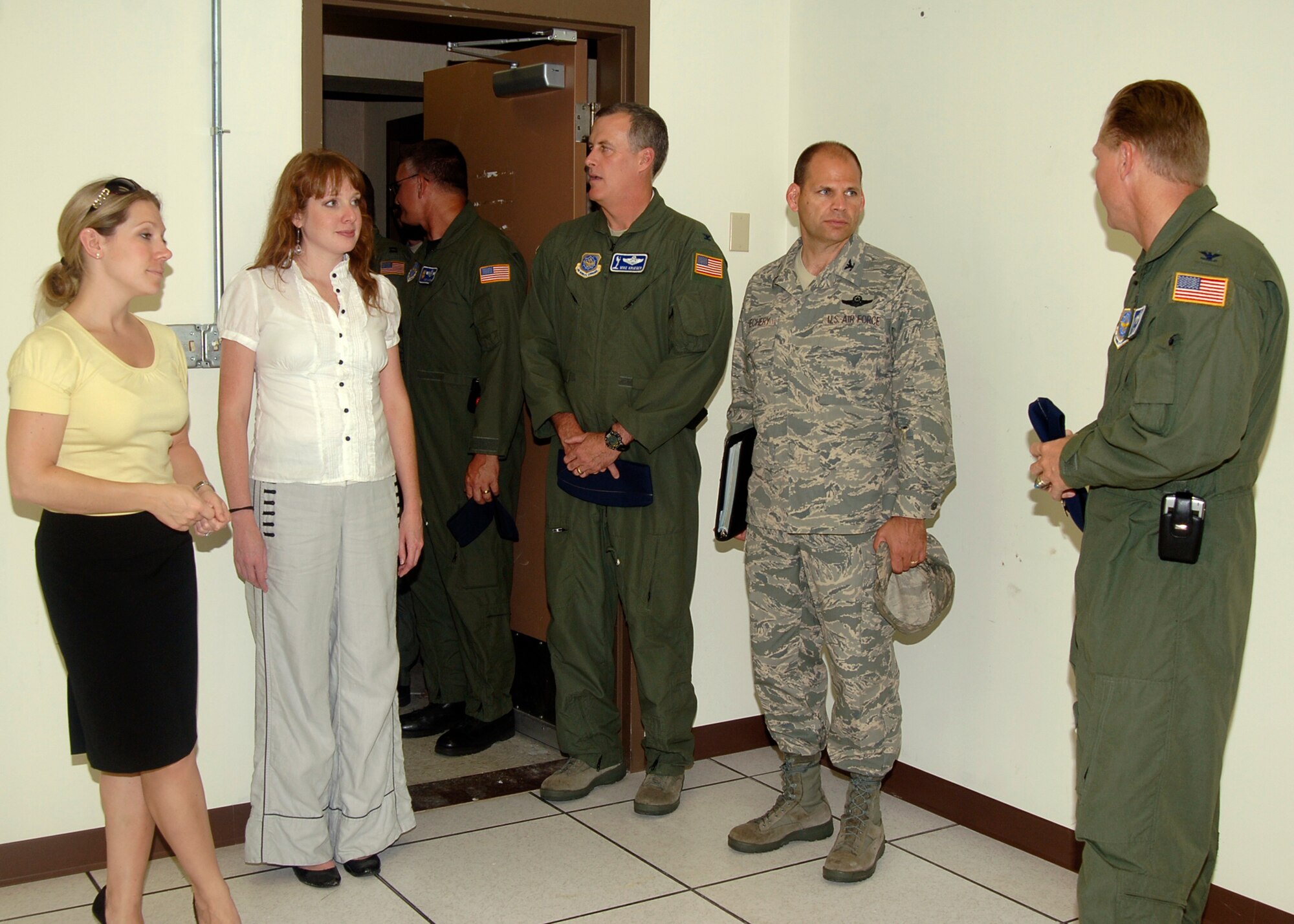 MCCONNELL AIR FORCE BASE, Kan. -- Colonel James Vechery, 22nd Air Refueling Wing commander, and Colonel Bart Weiss, 22nd Operations Group commander, inform Libby Burgess and Theda Owens, representatives of Sen. Pat Roberts, on the differences in the buildings that house the flight simulators during their tour of the base, Aug. 22. Ms. Burgess and Owens toured the old flight simulator building followed by the current building for comparison. (Photo by Airman Justin Shelton)