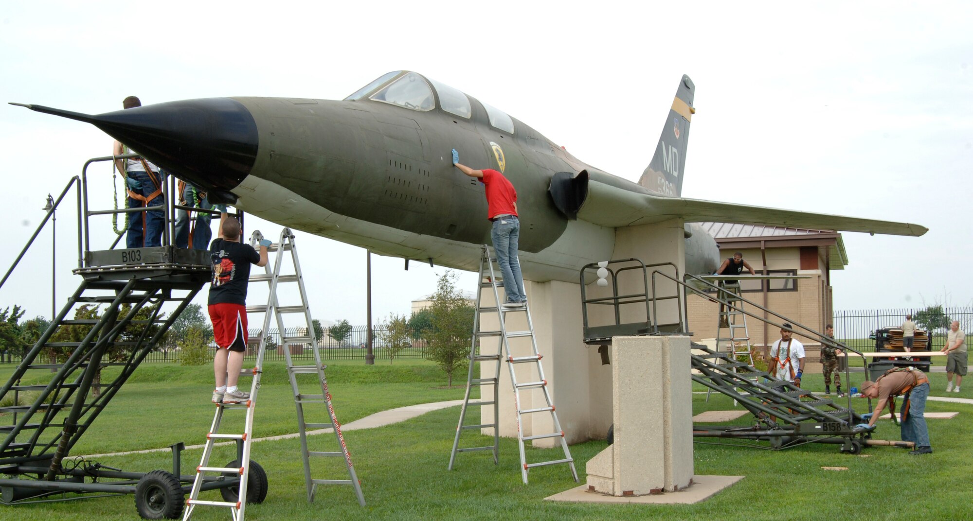MCCONNELL AIR FORCE BASE, Kan. -- Members from the 22nd Maintenance Squadron refurbish an F-105 Thunderchief at the visitor’s center, Aug. 18. One of the first U. S. combat aircraft to see action in the Vietnamese War, this F-105 Thunderchief has the title “Last of the Mohicans”.  (Photo by Senior Airman Roy Lynch III)