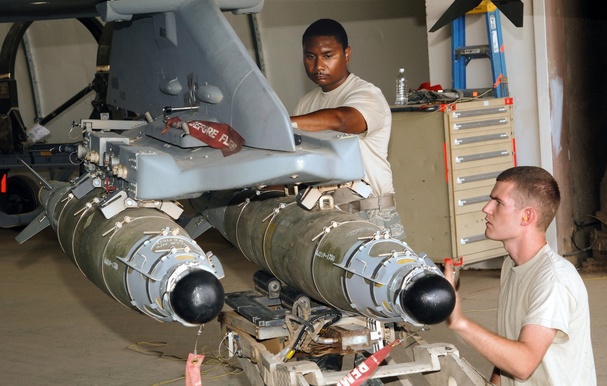 Staff Sgts. Michael Jackson and Anthony Bagen align a 500-pound guided bomb unit-54 laser joint direct attack munition before connecting it to an F-16 Fighting Falcon Aug. 14 at Joint Base Balad, Iraq. Two F-16 pilots with the 77th Expeditionary Fighter Squadron here employed a GBU-54 Aug. 12 against a moving enemy vehicle in the Diyala province to support a combined Iraqi army and U.S. Marine operation. Sergeant Bagen, a weapons load crew chief with the 77th EFS, is originally from Tampa, Fla. Sergeant Jackson, a weapons load crewmember with the 77th EFS, is originally from Union Springs, Ala. Both are deployed here from Shaw Air Force Base, S.C. (U.S. Air Force photo/Tech. Sgt. Erik Gudmundson) 
