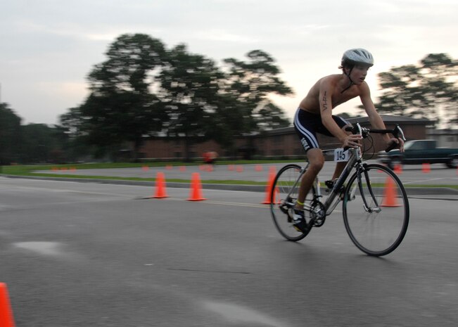 DJ VanMaanen finishes the 14,500 meter bicycling portion of the triathlon on Charleston AFB Aug. 23. Events during the triathlon consisted of a 450 meter swim and a 5,000 meter run.The fitness center held the fifth annual triathlon to test people's fitness and allow a healthy extracurricular activity.  DJ is the 15-year-old son of Lt. Col. Karen Wade. (U.S. Air Force photo/Airman 1st Class Katie Gieratz)