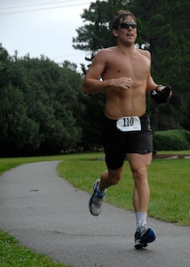 Christopher Fidrych sprints to the finish line of the 5,000 meter run during the triathlon on Charleston AFB Aug. 23. Besides running Fidrych swam 450 meters and biked 15,500 meters. The fitness center held the fifth annual triathlon to test people's fitness and allow a healthy extracurricular activity. Fidrych is a member of the U.S. Navy. (U.S. Air Force photo/Airman 1st Class Katie Gieratz)