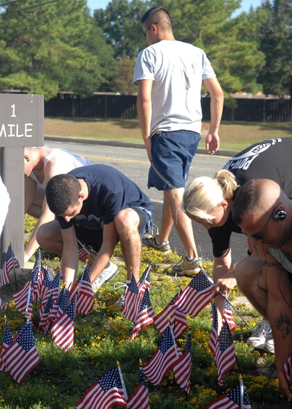 At the half-way mark of a two-mile run event called Run for the Fallen on Seymour Johnson Air Force Base, N.C., each runner placed an American flag in the ground. Participants planted flags at each mile marker to symbolize a military member who was killed supporting the War on Global Terror, Aug 24. (U.S. Air Force photo by Airman 1st Class Makenzie Lang) 
