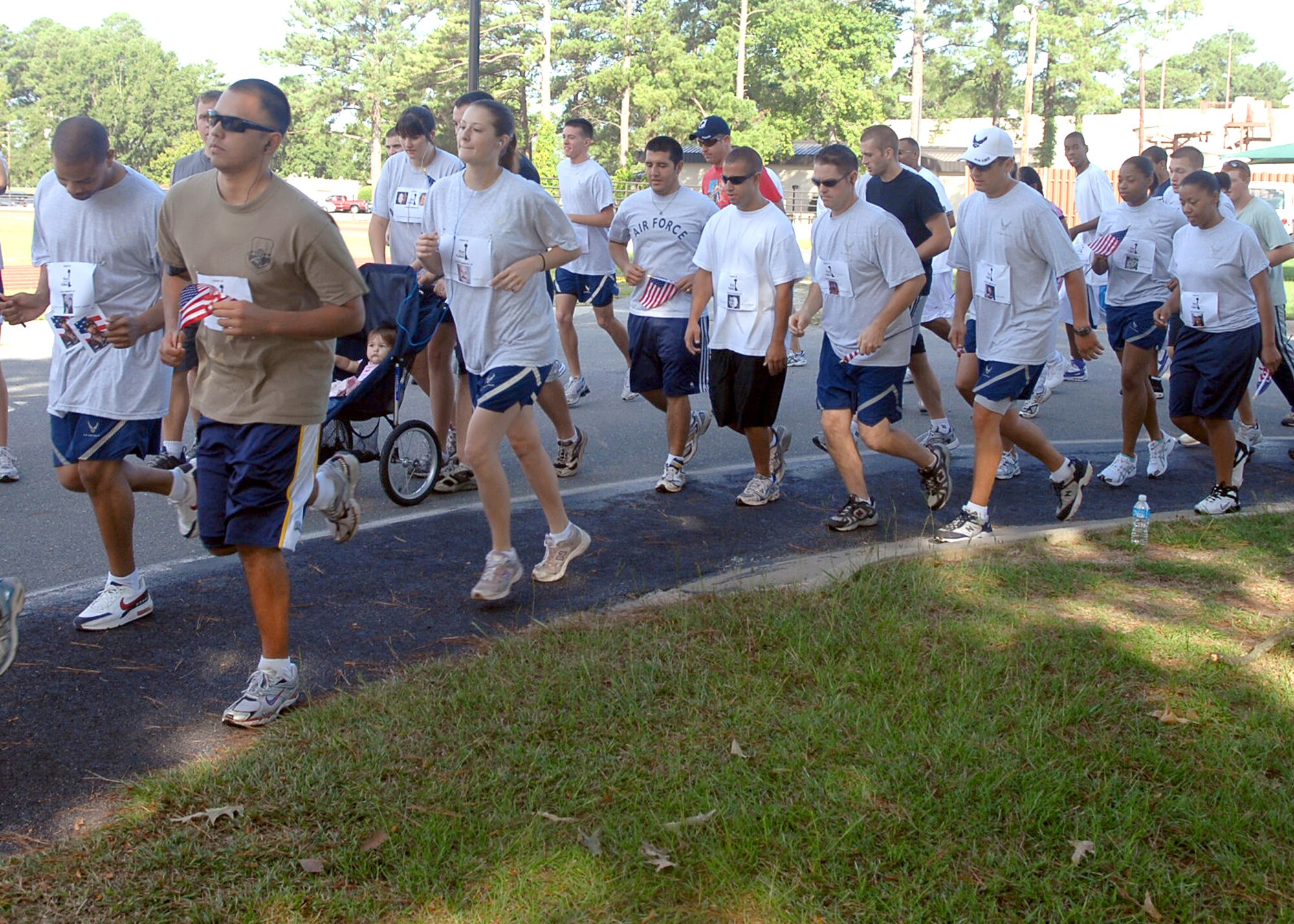 Runners get their start on a two-mile event called Run for the Fallen on Seymour Johnson Air Force Base, NC, August 24. Run for the Fallen was held to honor military members who lost their lives in Operation Iraqi Freedom and Operation Enduring Freedom. Participants wore running bibs with the name, rank, branch of service and picture of these fallen military members. (U.S. Air Force photo by Airman 1st Class Makenzie Lang)