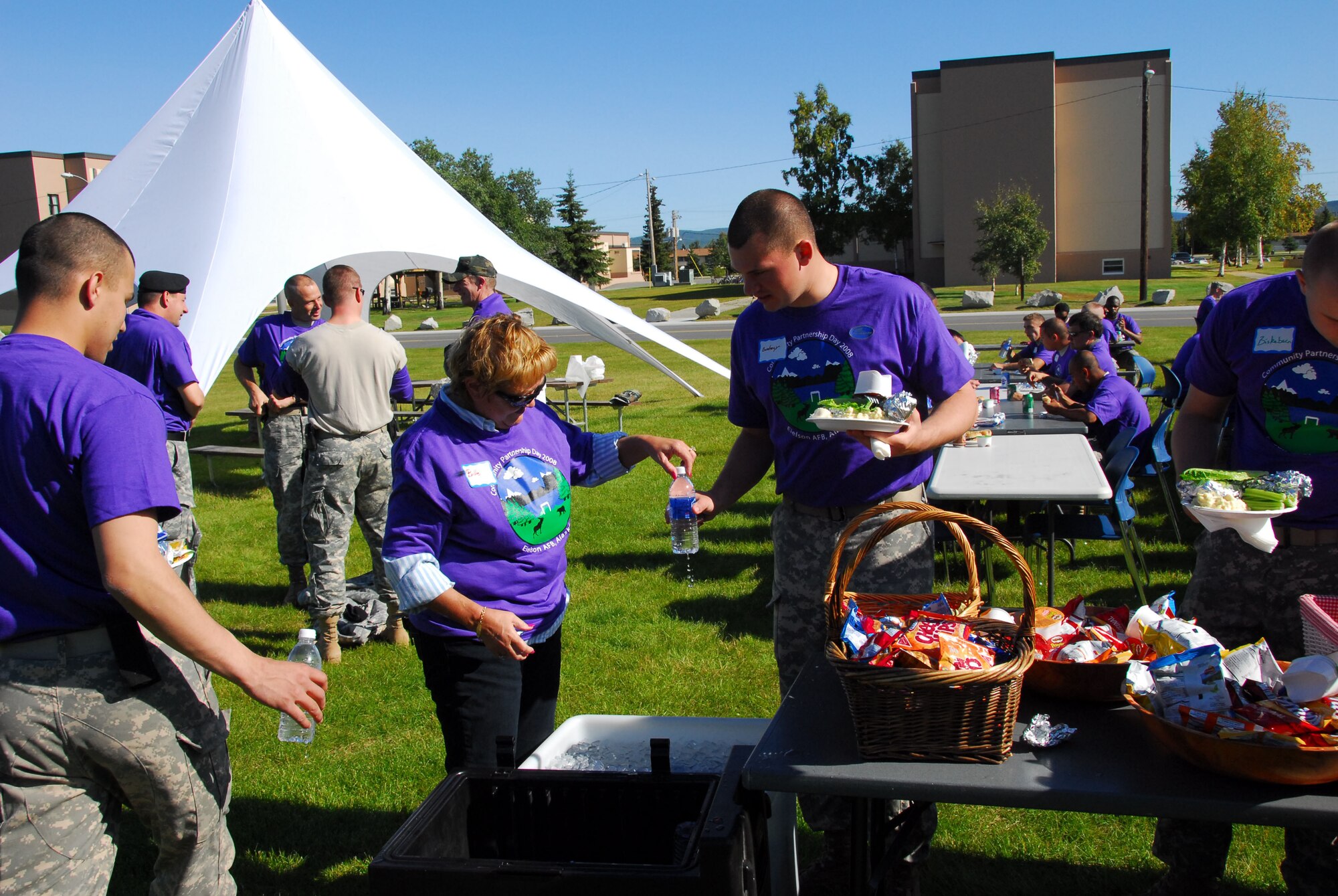 Volunteer Billie Blanchard distributes drinks to Army, Air Force and other volunteers outside Two Seasons Dining Facility on Eielson Air Force Base as part of Community Partnership Day Aug. 22, 2008. Community Partnership Day enhanced the base this year by planting trees and building new picnic tables. (U.S. Air Force photo/Staff Sgt. Shad Eidson)