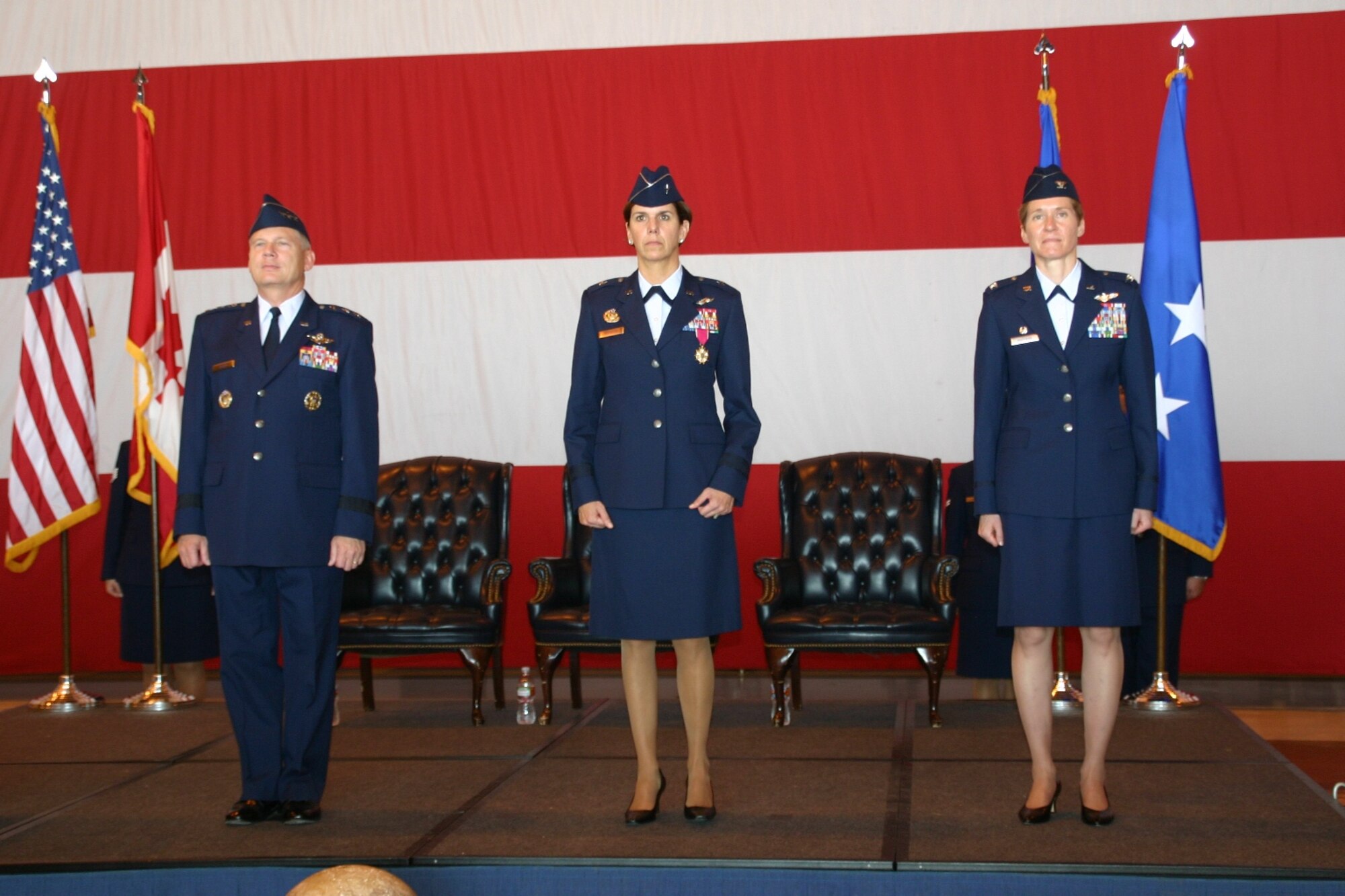 The official party stands at attention during the chang of command ceremony. From left to right: Lt. Gen. Robert Elder, Commander, 8th Air Force; Brig. Gen. Lori Robinson, outgoing 552 Air Control Wing Commander; and Col. Patricia Hoffman, incoming 552 Air Control Wing Commander.