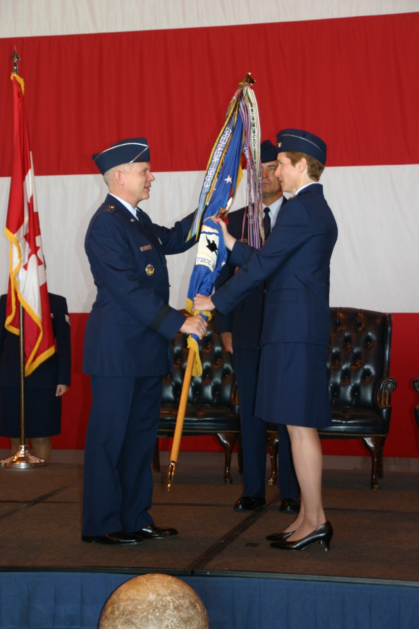 Lt. Gen. Robert Elder, Commander, 8th Air Force, passes the flag, and command of the 552nd Air Control Wing to Col. Patricia Hoffman in a change of command ceremony August 27th. Photo Courtesy of 2nd Lt. Kinder Blacke.