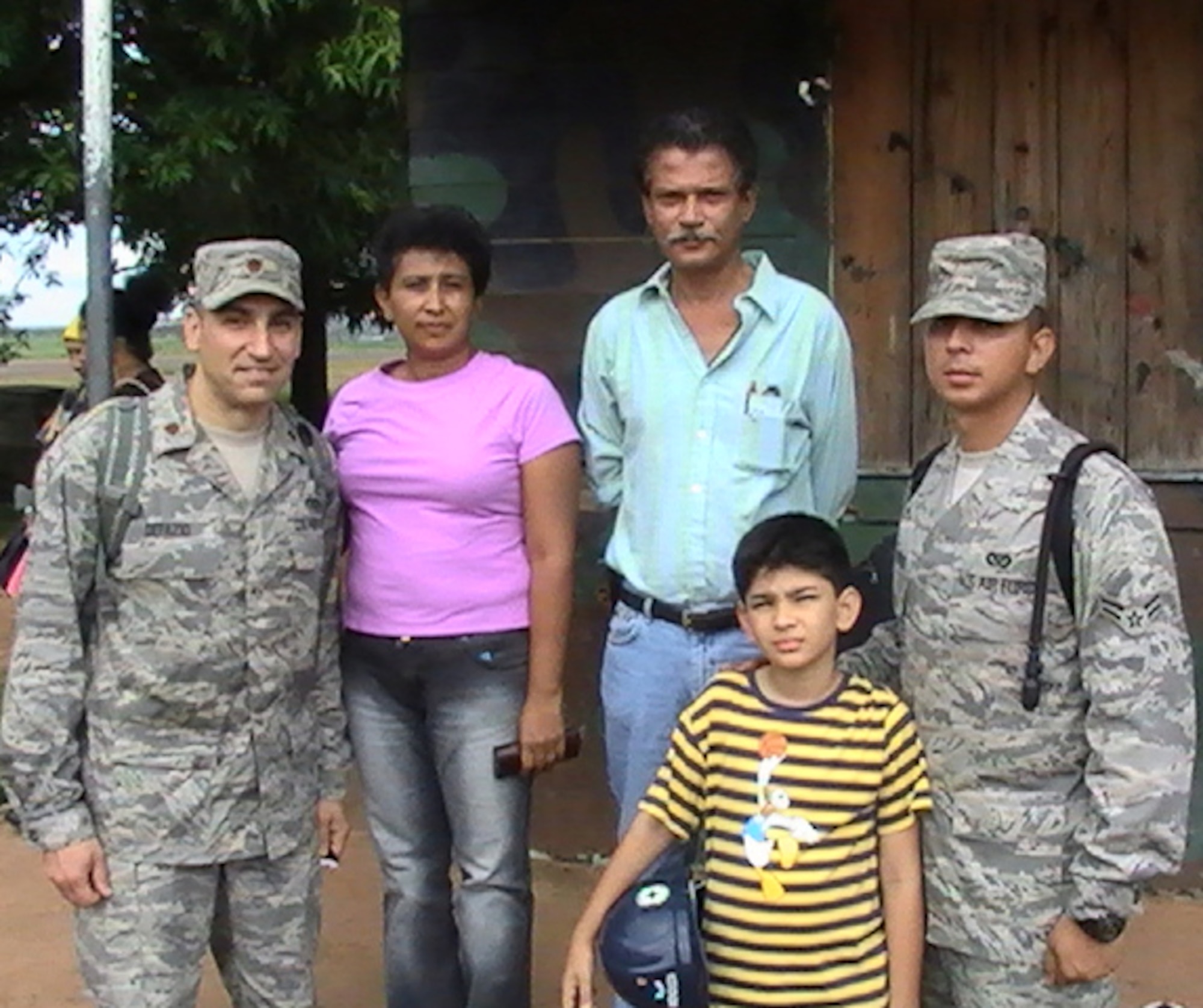 PUERTO CABEZAS, Nicaragua – Airman 1st Class Joel Mendoza (far right), 5th Civil Engineer Squadron entomology apprentice, and Maj. Thomas DeFazio (far left), 5th CES contingency engineer forces commander, pose for a photo with Airman Mendoza’s recently reunited family here recently during the Caribbean Phase of Continuing Promise 2008. Airman Mendoza left his home in Managua, Nicaragua almost 3 years ago when he married a U.S. citizen and moved to America.  He joined the Air Force last year and received his U.S. citizenship in June. He is one of 40 5th CES Airmen from Minot Air Force Base participating in this 4-month mission. (Courtesy photo)