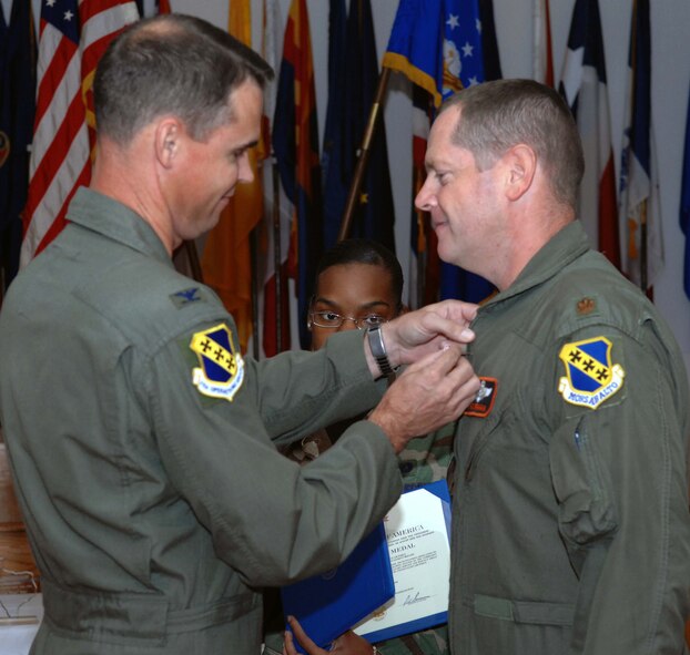 DYESS AIR FORCE BASE, Texas -- Colonel Charles Catoe, 7th Operations Group Commander pins the Bronze Star to Major Fred Graham, Director of Training, 436th Training Squadron here, 22 Aug.  Major Graham received the prestigious medal for distinguishing himself by exceptionally meritorious conduct in support of Operation Iraqi Freedom while working with the Army as Electronic Warfare Officer. (U.S. Air Force photo Staff Sergeant Connor Estes).  