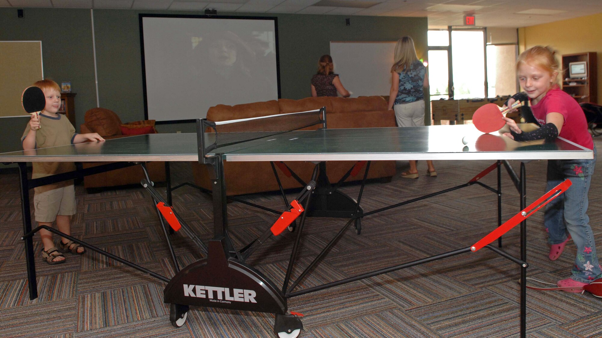 DYESS AIR FORCE BASE, Texas -- Two children, military dependents, enjoy a game of ping pong during the opening of the new Youth Center here, Aug 19 .  The Youth Center allows Dyess kids a safe place to participate in sports, games, clubs and other other activities. (U.S. Air Force photo Staff Sergeant Connor Estes).   