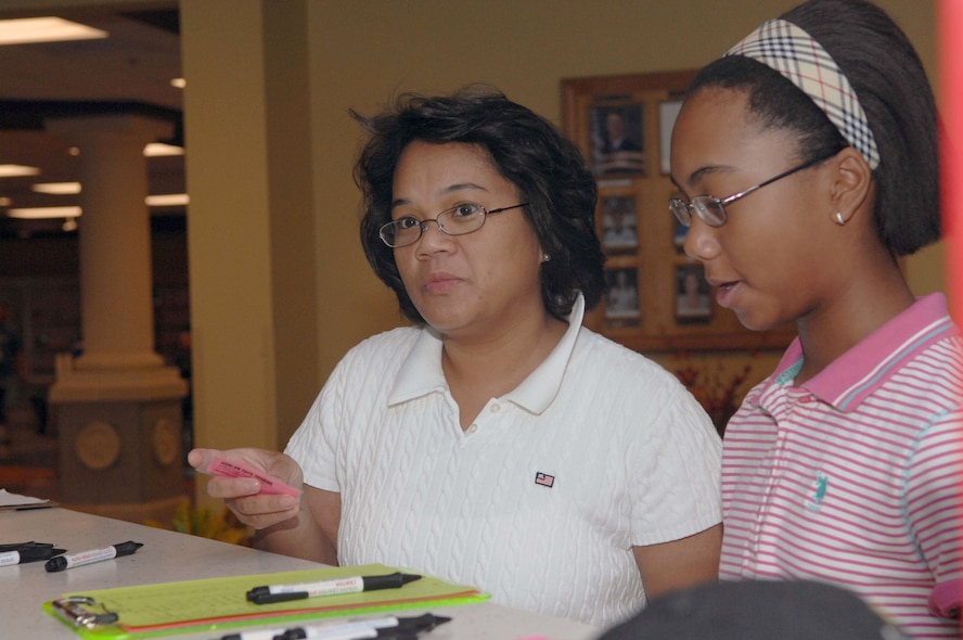 DYESS AIR FORCE BASE, Texas -- Mrs. Tip Womack and daughter Jessica, age 12, sign in to the new Youth Center on opening day here, Aug 19. The Youth Center is vital to the base allowing a safe place to keep Dyess kids active with sports, games, clubs and different other functions to be involved in.  (U.S. Air Force photo Staff Sergeant Connor Estes).      