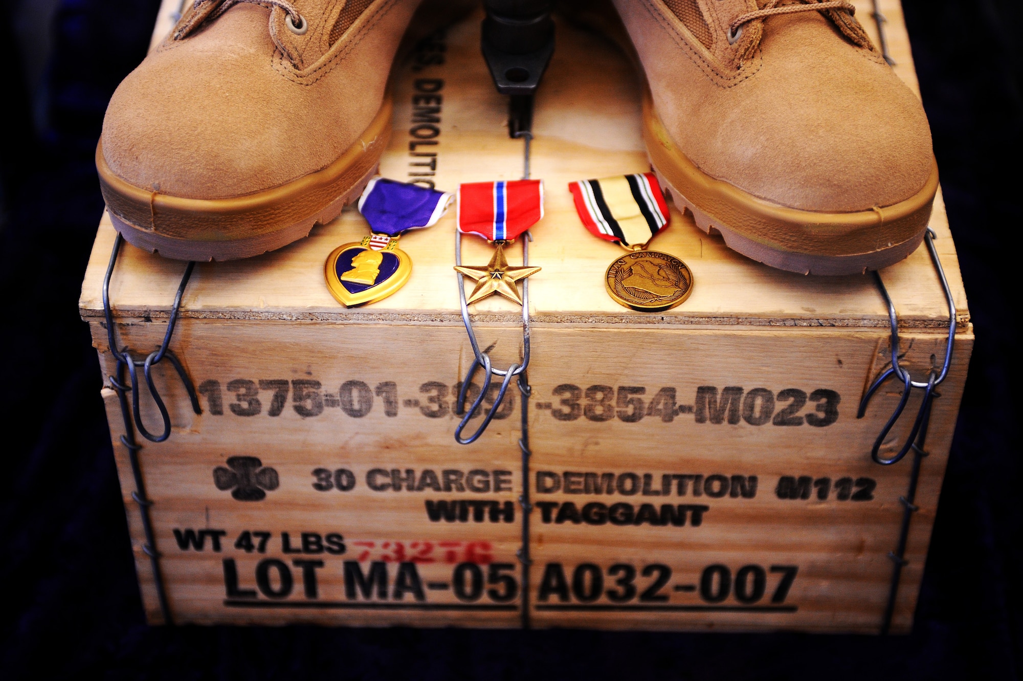 A purple heart, bronze star and Iraqi campaign medals are placed at the front of the boots on Master Sgt. Brad Clemmons, 354th Civil Engineer Squadron explosive ordnance disposal flight, memorial Aug. 21, 2008 at Eielson Air Force Base, Alaska. Sergeant Clemmons family, friends and co-workers attended the building dedication ceremony to honor his ultimate sacrifice.  (U.S. Air Force photo by Airman 1st Class Jonathan Snyder)