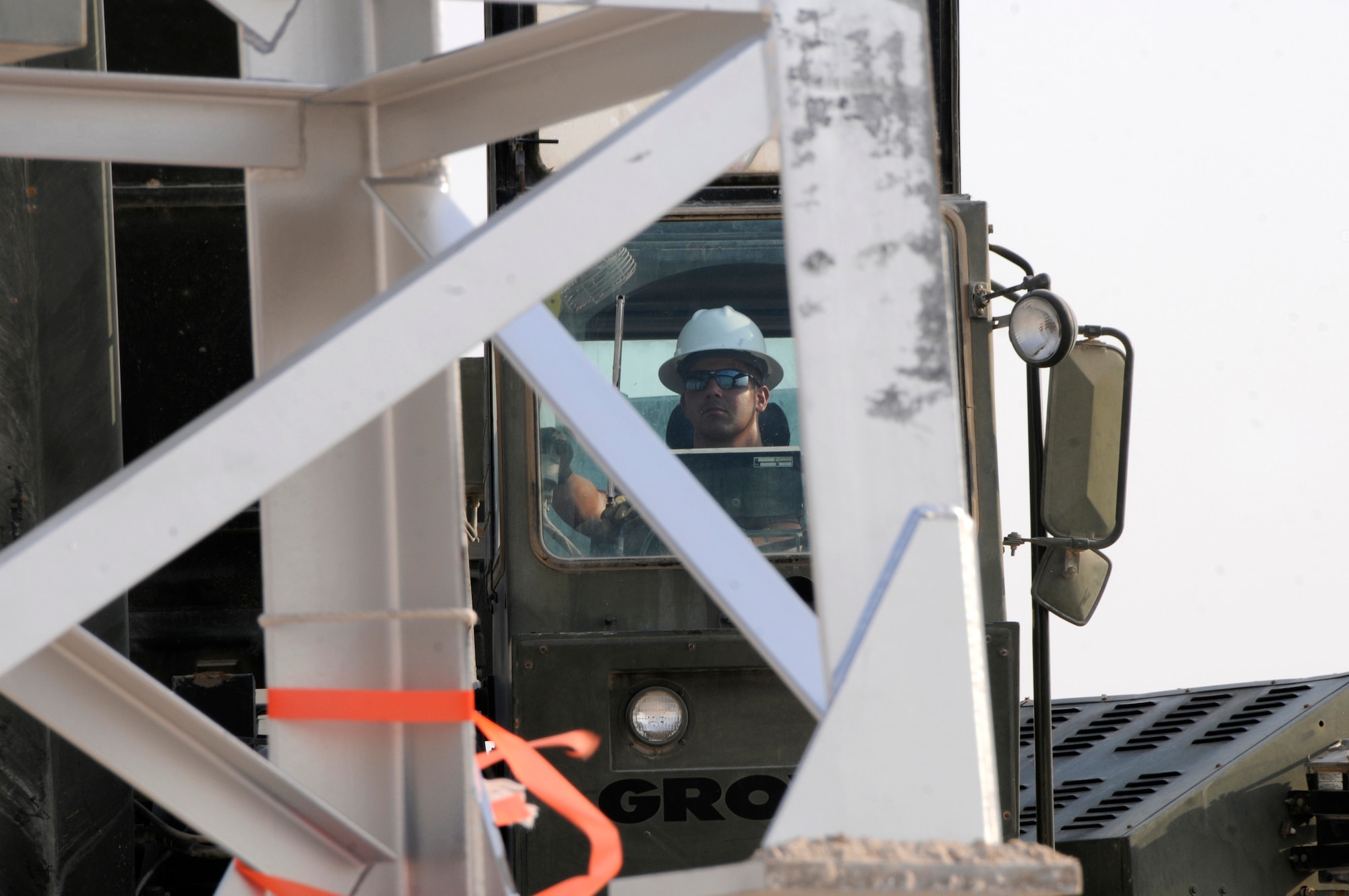 Senior Airman Kyle Troxell, 379th Expeditionary Civil Engineer Squadron, gently manipulates a 60-ton crane, efficiently moving the new Giant Voice tower into place Aug. 26, 2008, at an undisclosed location in Southwest Asia. Airman Troxell is a member of a team exchanging aging towers with a sturdier replacement that should last nearly twice as long.  The Giant Voice system is used to communicate important information to all base populace instantaneously. Airman Troxell is deployed from Scott Air Force Base, Ill., in support of Operations Iraqi and Enduring Freedom and Joint Task Force-Horn of Africa.  (U.S. Air Force photo by Tech. Sgt. Michael Boquette/Released)