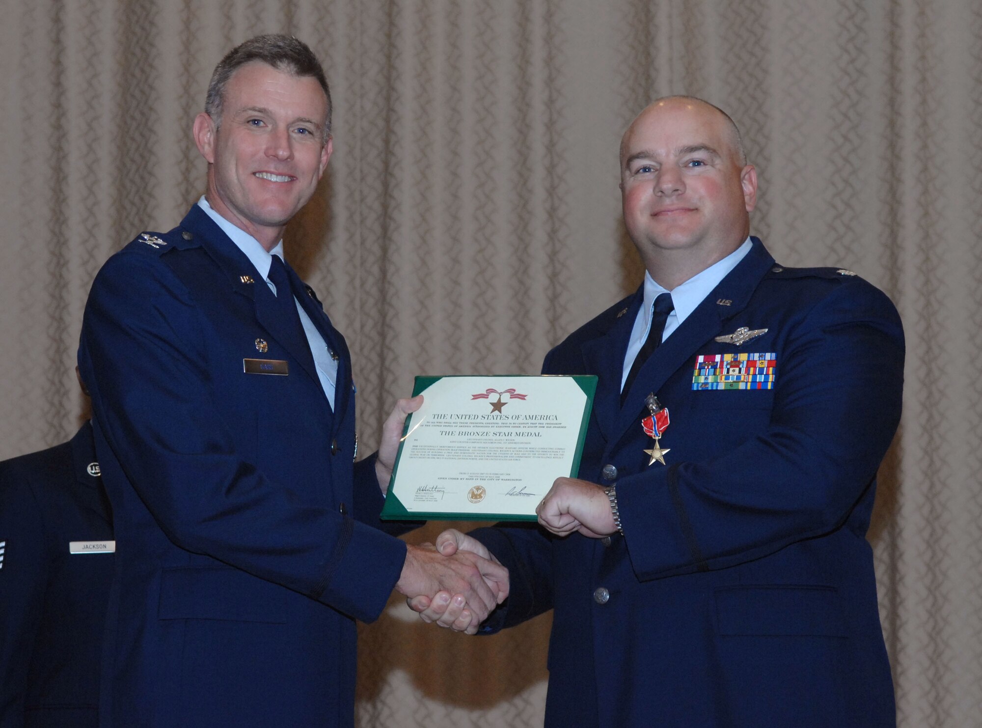 DYESS AIR FORCE BASE, Texas -- Lieutenant Colonel Allen Wilson, 7th OSS Mission Training Center director, received the Bronze Star Medal by 7th Bomb Wing Commander Colonel Robert Gass here, 21 Aug.  Colonel Wilson and two other Airmen received the prestigious medal for distinguishing themselves by exceptionally meritorious conduct in support of Operation Iraqi Freedom while working with the Army. (U.S. Air Force photo Staff Sergeant Connor Estes).   