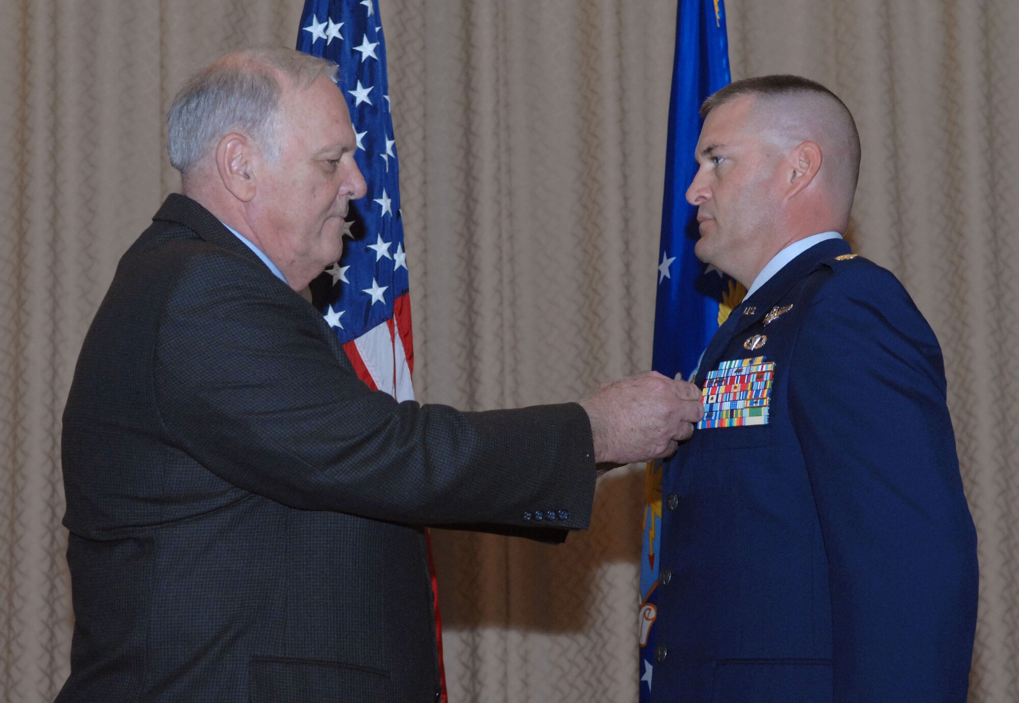 DYESS AIR FORCE BASE, Texas -- Major Scott Mansfield, 7th Operation Support Squadron B-1 Bomber flight scheduling officer, received the Bronze Star Medal by Major (retired) Tom Mansfield here, 21 Aug.  Major Mansfield and two other Airmen received the prestigious medal for distinguishing themselves by exceptionally meritorious conduct in support of Operation Iraqi Freedom while working with the Army. (U.S. Air Force photo Staff Sergeant Connor Estes).  
