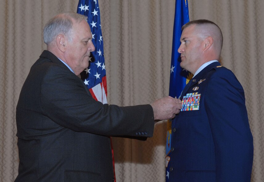 DYESS AIR FORCE BASE, Texas -- Major Scott Mansfield, 7th Operation Support Squadron B-1 Bomber flight scheduling officer, received the Bronze Star Medal by Major (retired) Tom Mansfield here, 21 Aug.  Major Mansfield and two other Airmen received the prestigious medal for distinguishing themselves by exceptionally meritorious conduct in support of Operation Iraqi Freedom while working with the Army. (U.S. Air Force photo Staff Sergeant Connor Estes).  