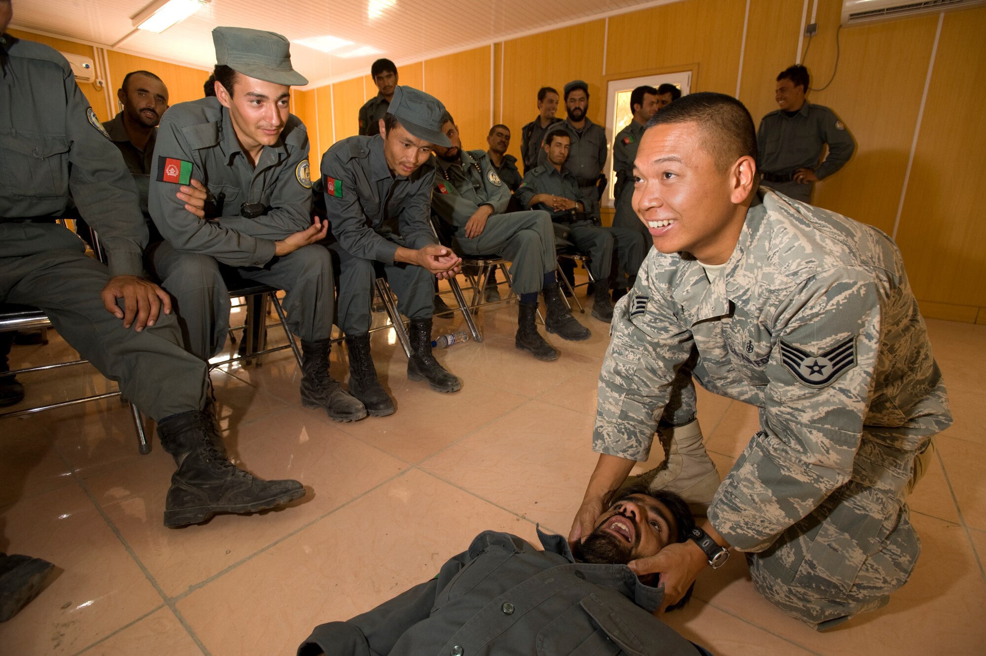 QALAT, Afghanistan -- Staff Sgt. Nestor Albanos shows Afghan National Police how to open an airway during a Combat Live Savers course here Aug. 12. Sergeant Albanos, an Air Force medical technician is assigned to the Zabul Provincial Reconstruction Team and teaches the ANP and other Afghan forces CLS at the PRT compound.  (U.S. Air Force photo by Master Sgt. Keith Brown)


