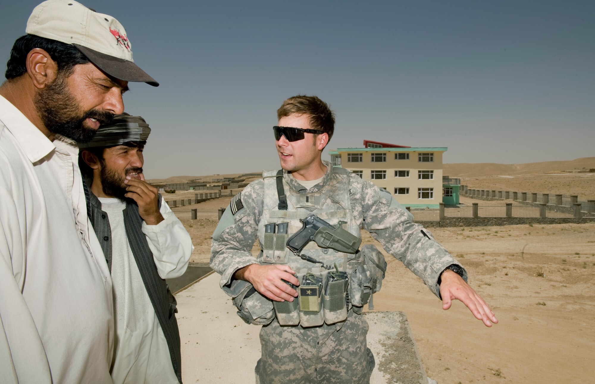 QALAT, Afghanistan -- Air Force 1st Lieutenant Adam Lazar discusses progress on the construction of a new fire station here August 11th. As an engineer for the Zabul Provincial Reconstruction Team Lieutenant Lazar oversees 25 construction projects contracted out to local firms. (U.S. Air Force Photo by Master Sgt. Keith Brown)
